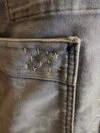 sashiko stitching on pocket – Lower front hem with final button and age patina on the moleskin.