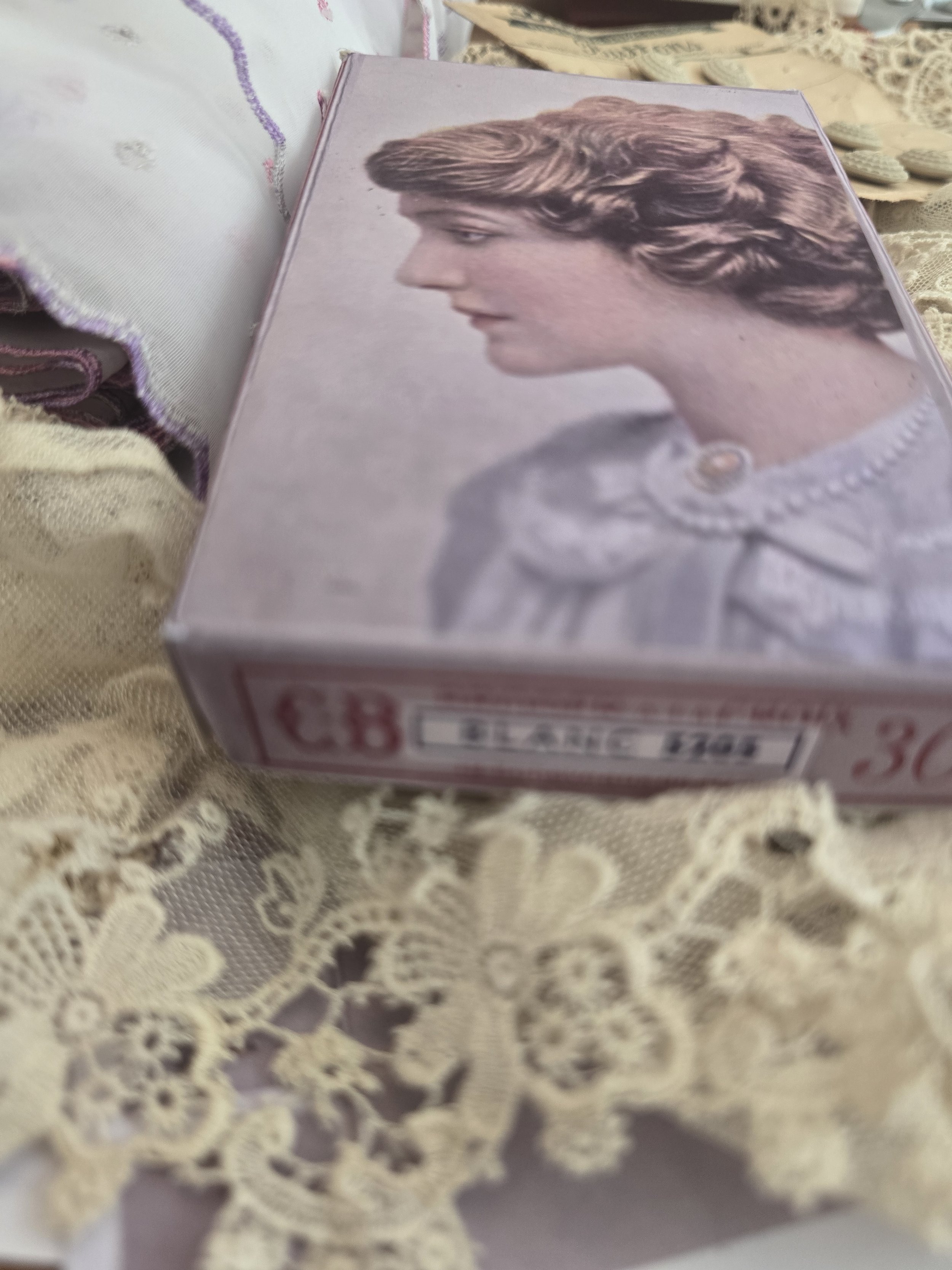 Side view of handmade blush pink haberdashery box featuring a softly coloured vintage portrait and French label detail.