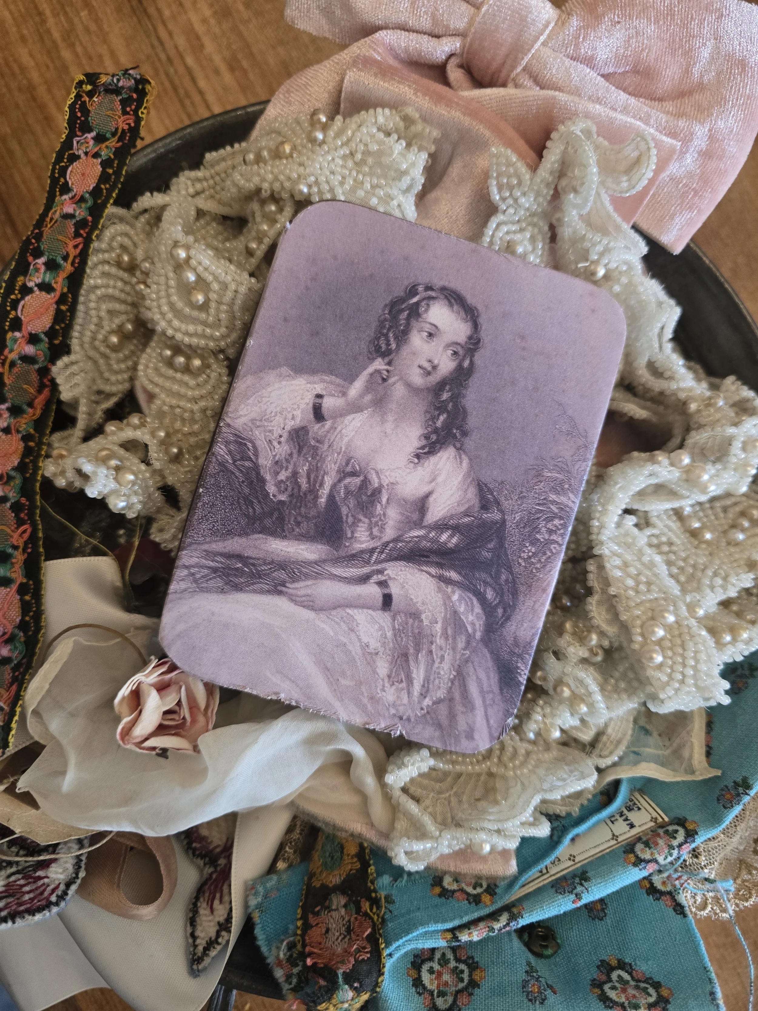 Studio Made vintage metal tin decorated with a softly faded antique portrait of a young woman.