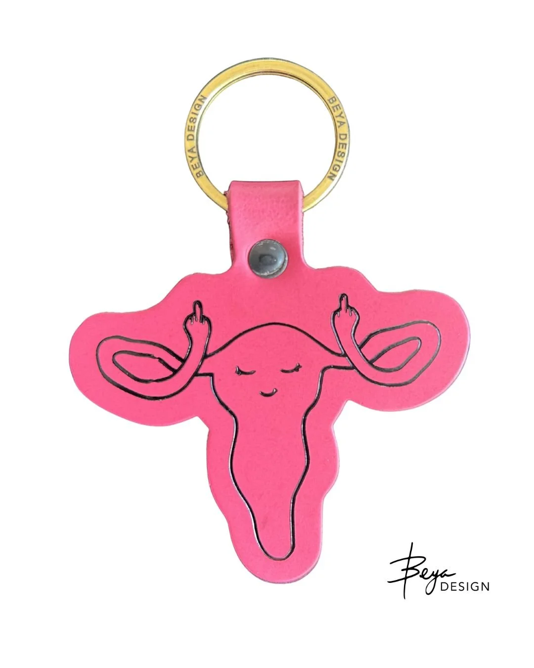 Sassy ragey uterus keychain in fuschia leather and black with a gold Beya Design keyring