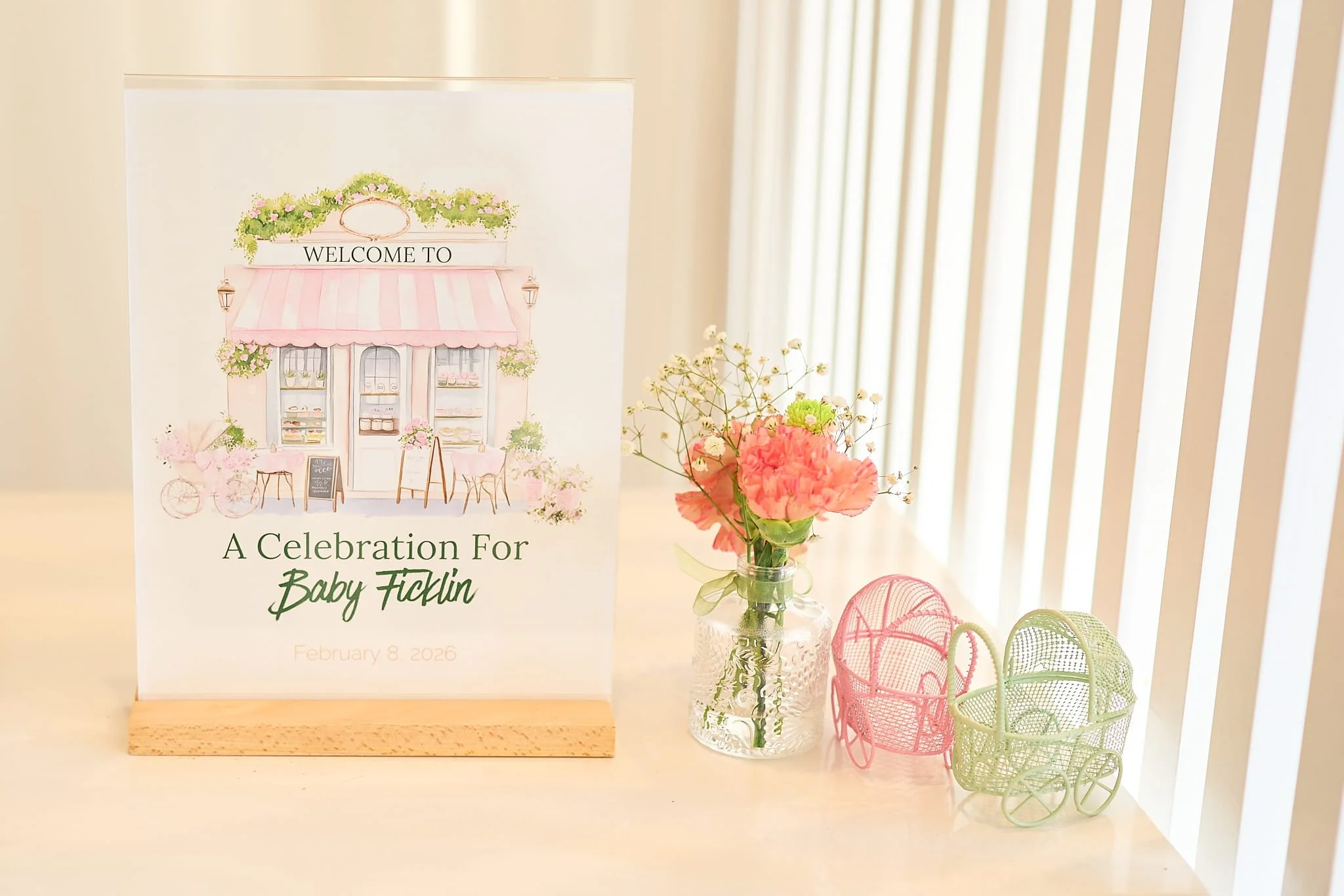 Cafe Bebe Welcome Sign with Bud Vase and Baby Carriage