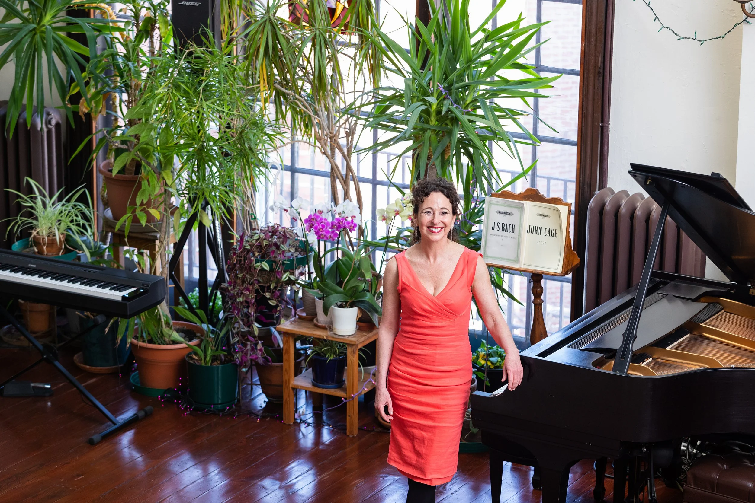 153 Andrea with Bach and Cage orange dress smile.jpeg