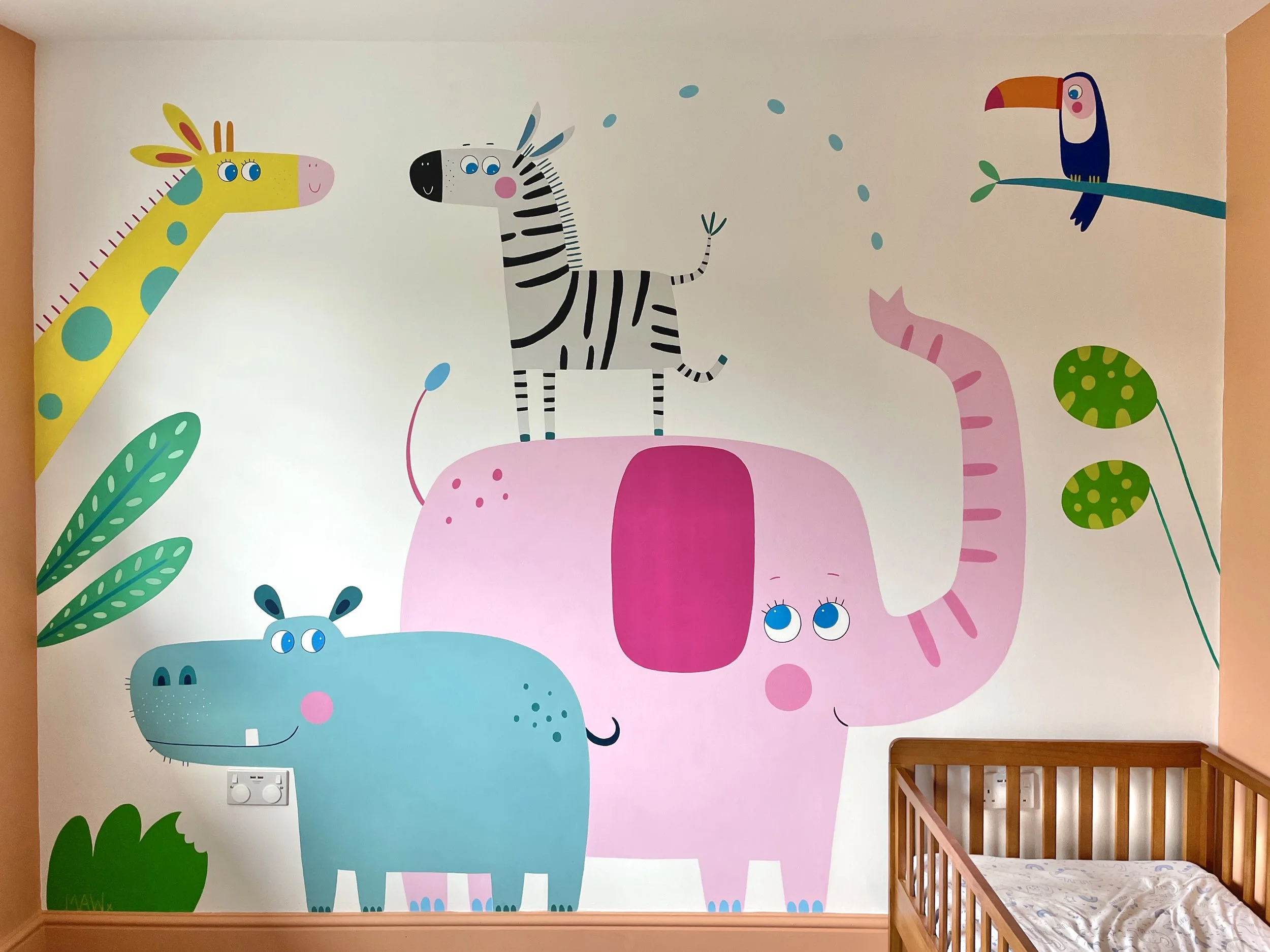 The finished custom-designed safari-themed wall mural for a child's bedroom, featuring an elephant, zebra, giraffe, hippo and toucan, by artist Melanie Williamson