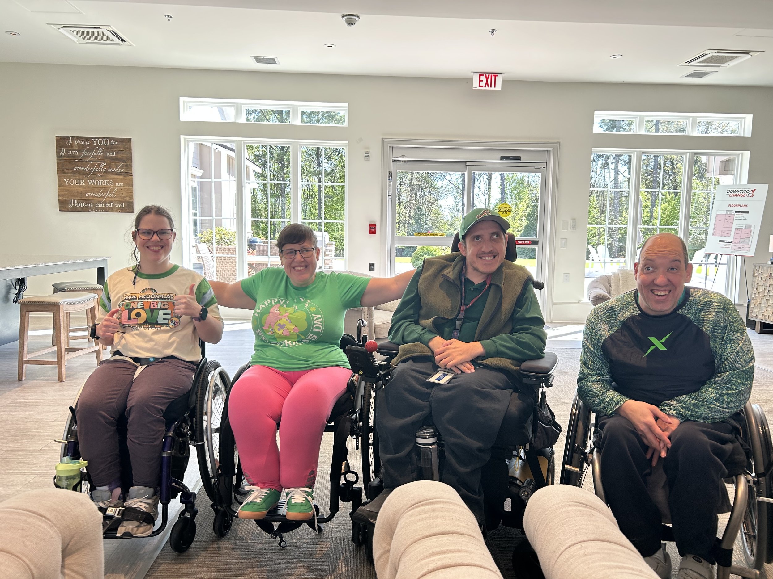 From left, residents Noelle Ford, Sarah Grace, Adam Laarhoven and Josh Cusick smile after participating in a group rowing workout session at Champions Place March 17.