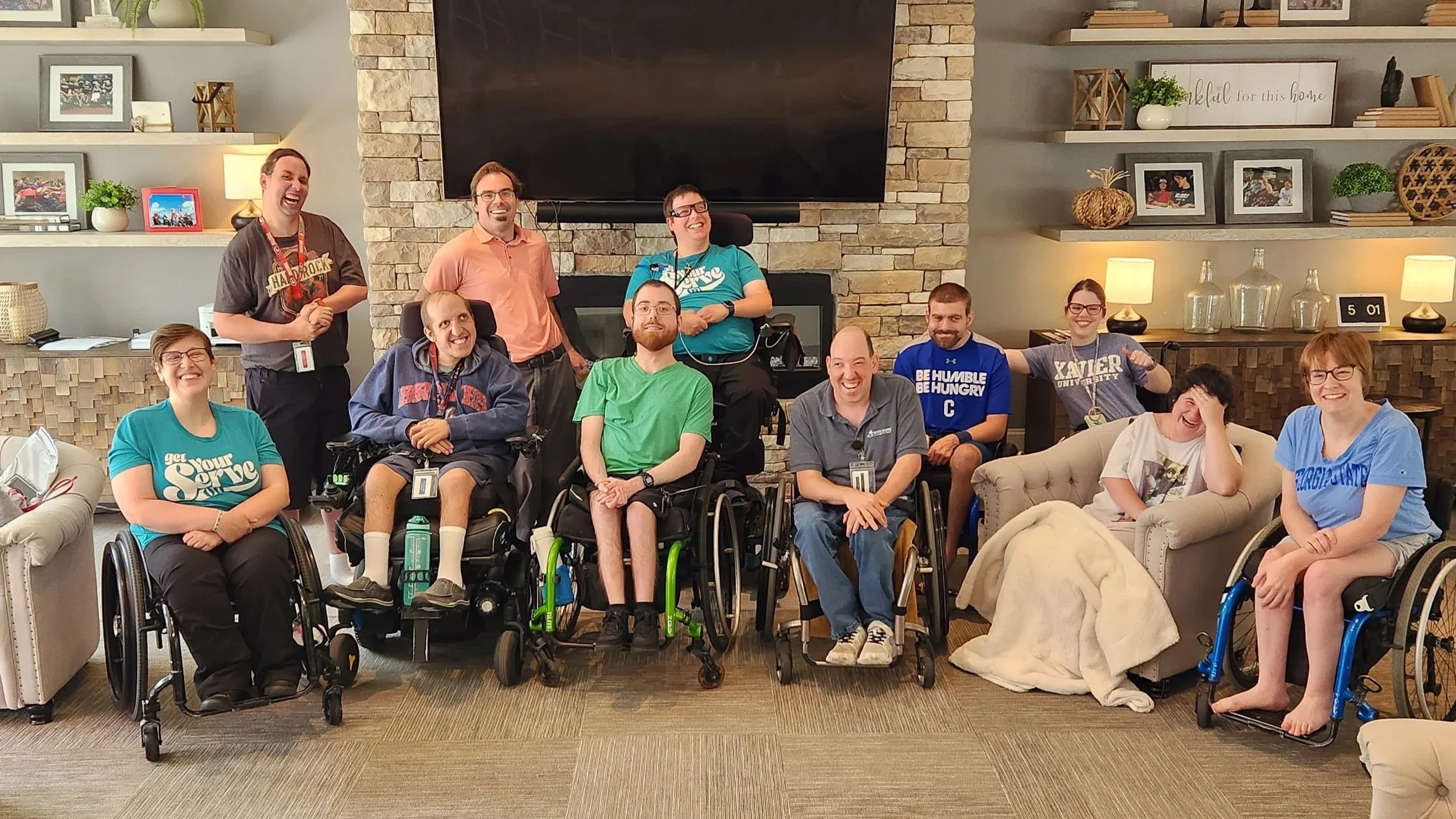 Residents at Champions Place gather for a photo in the family room.