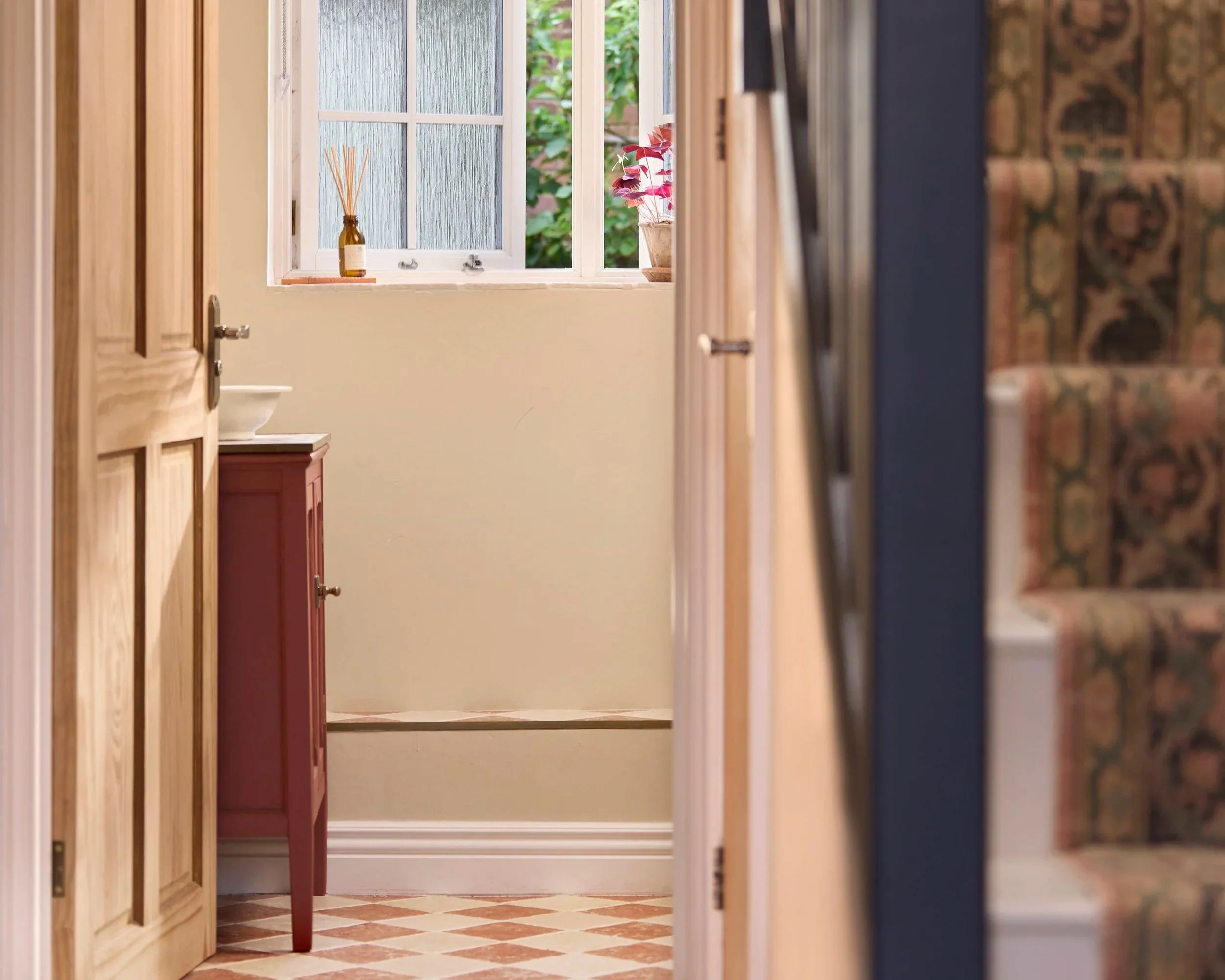 A view of a downstairs WC with checkerboard floor tiles