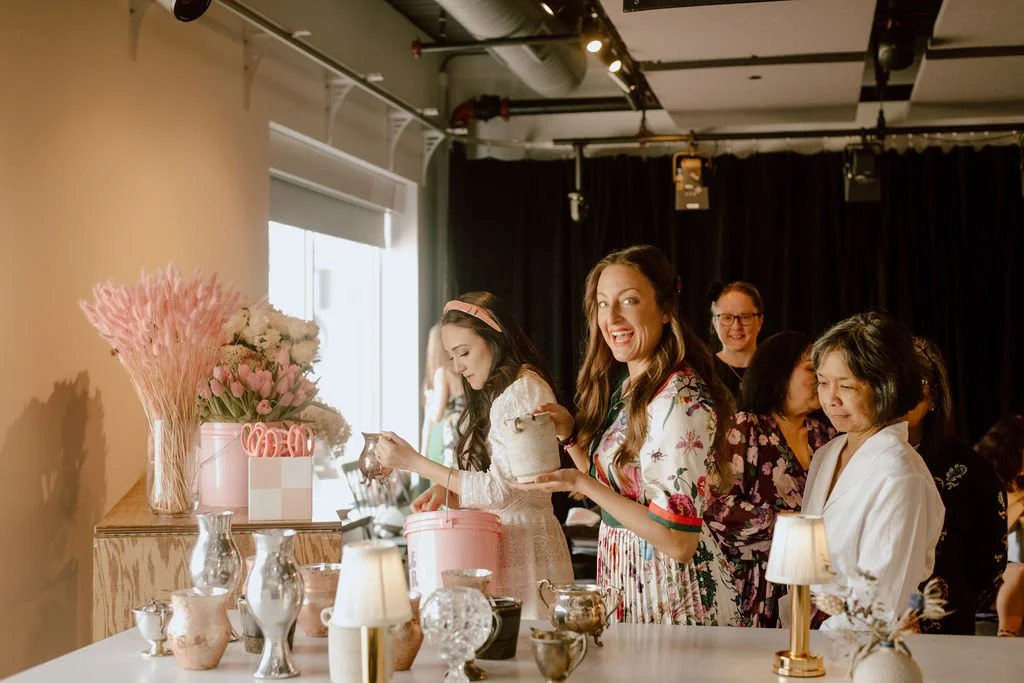 Women in line collecting supplies to make a floral arrangement