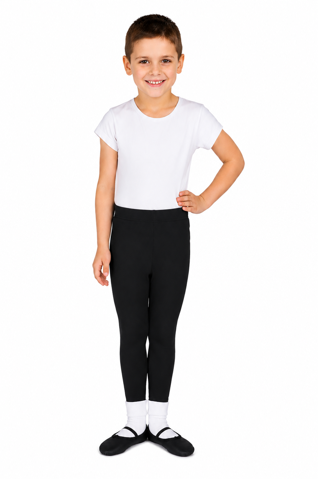 A young boy with short brown hair, wearing a white T-shirt, black leggings, and black socks, standing against a white background with a serious expression and one hand on his hip.