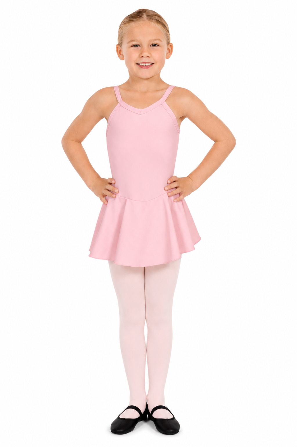 A young girl in a light pink ballet dress with a flared skirt, shown front and back, with her hands on her hips, smiling and with her hair in a bun.