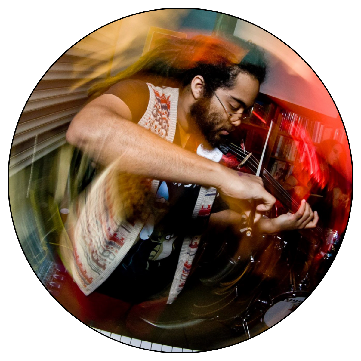 An image of composer Darian Donovan Thomas. He is playing the violin near a keyboard, with a colorful spiral photo effect surrounding him. Photo by Oscar Moreno
