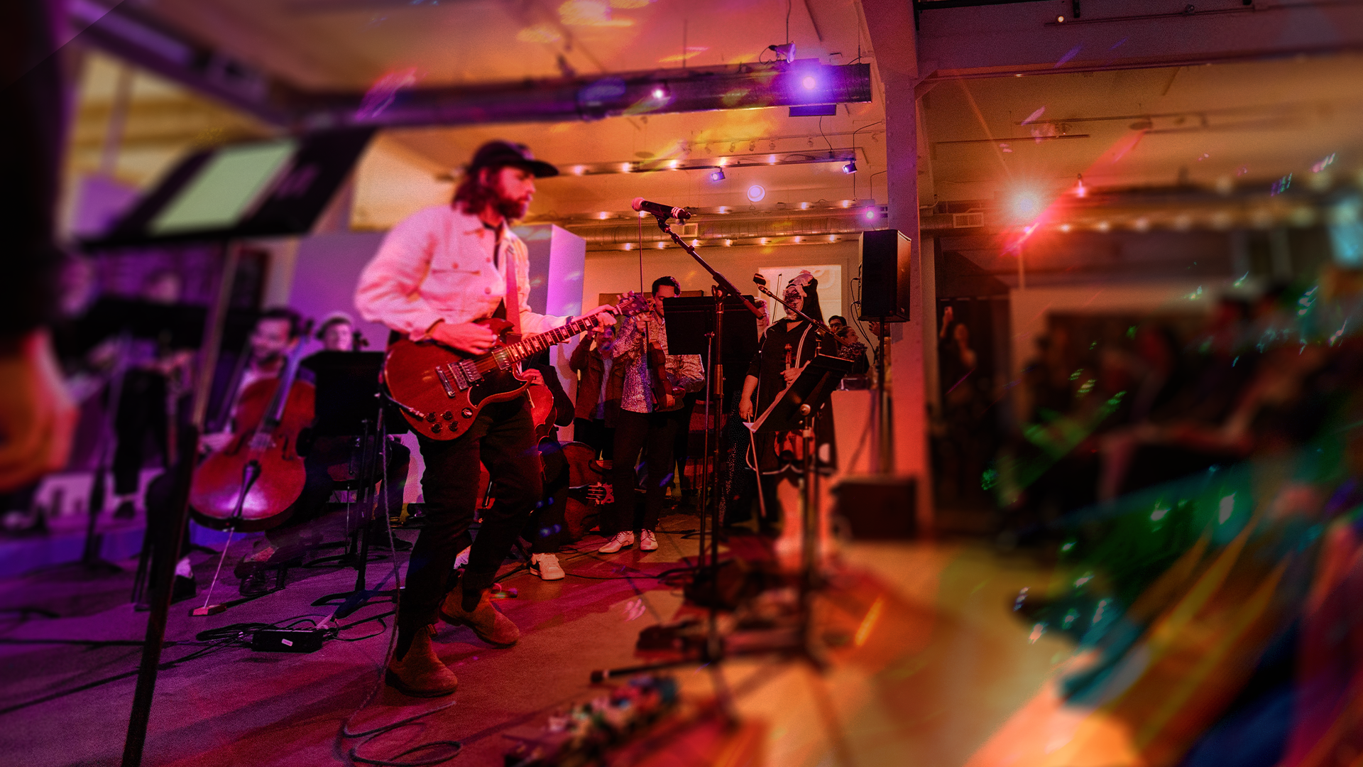 An image of a guitarist performing with an orchestra