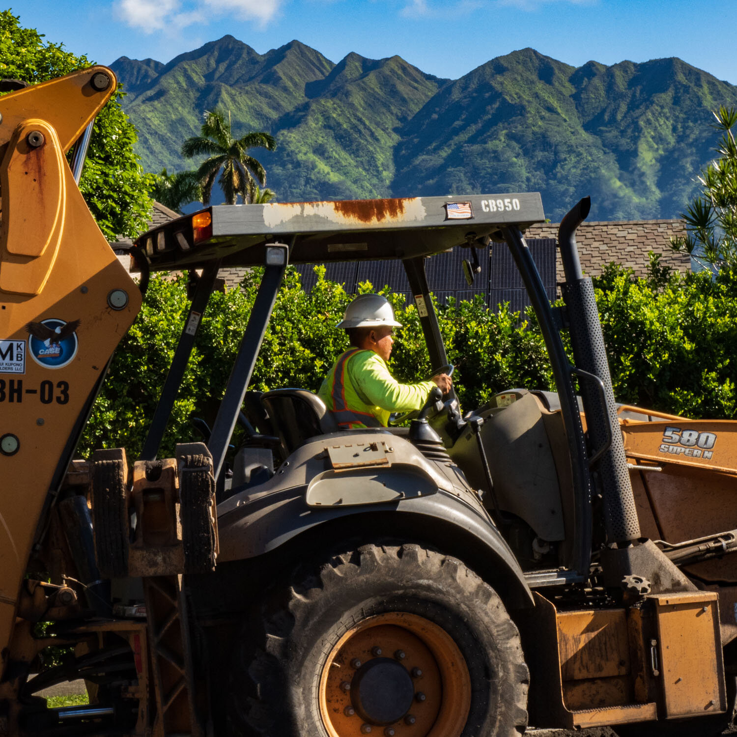 Driver of boackhoe road paving construction equipment in Manoa with mountains in background ©HowardWolff 20200227.jpg