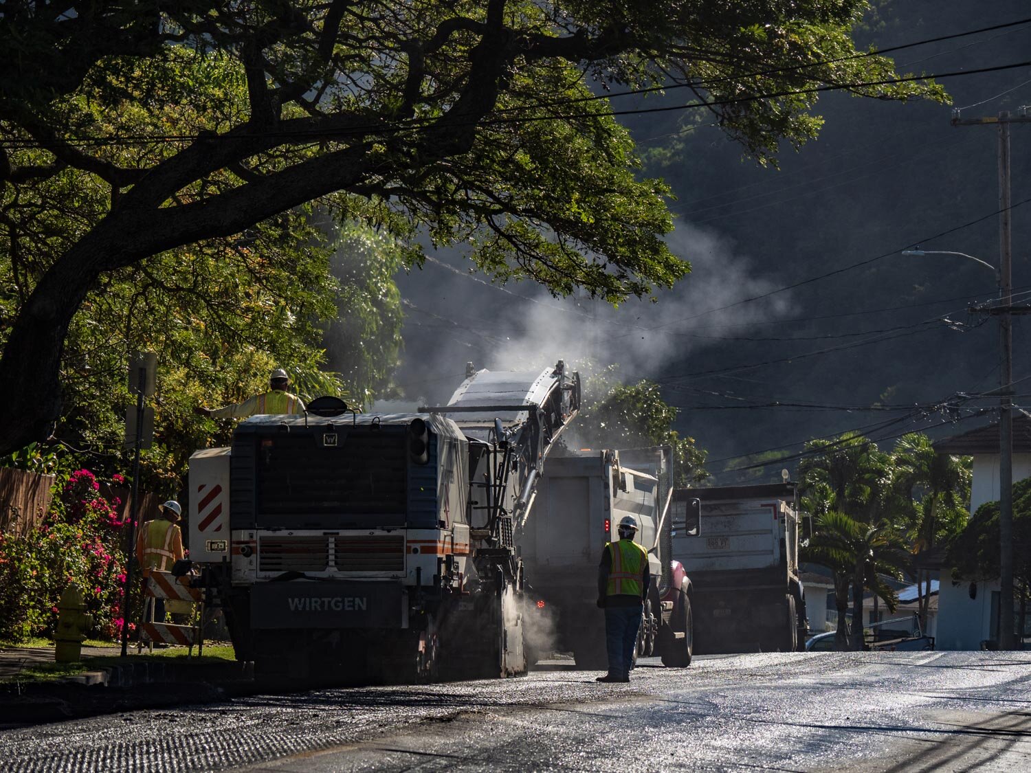 Driver of road paving construction equipment with smoke in Manoa ©HowardWolff 20200227.jpg