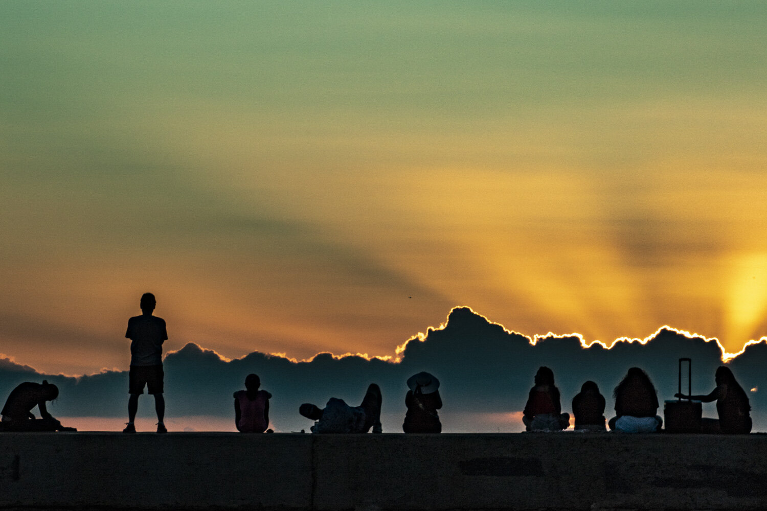 Silhouetted crowd watching sunset in Waikiki Magic Island ©HowardWolff 20180128.jpg