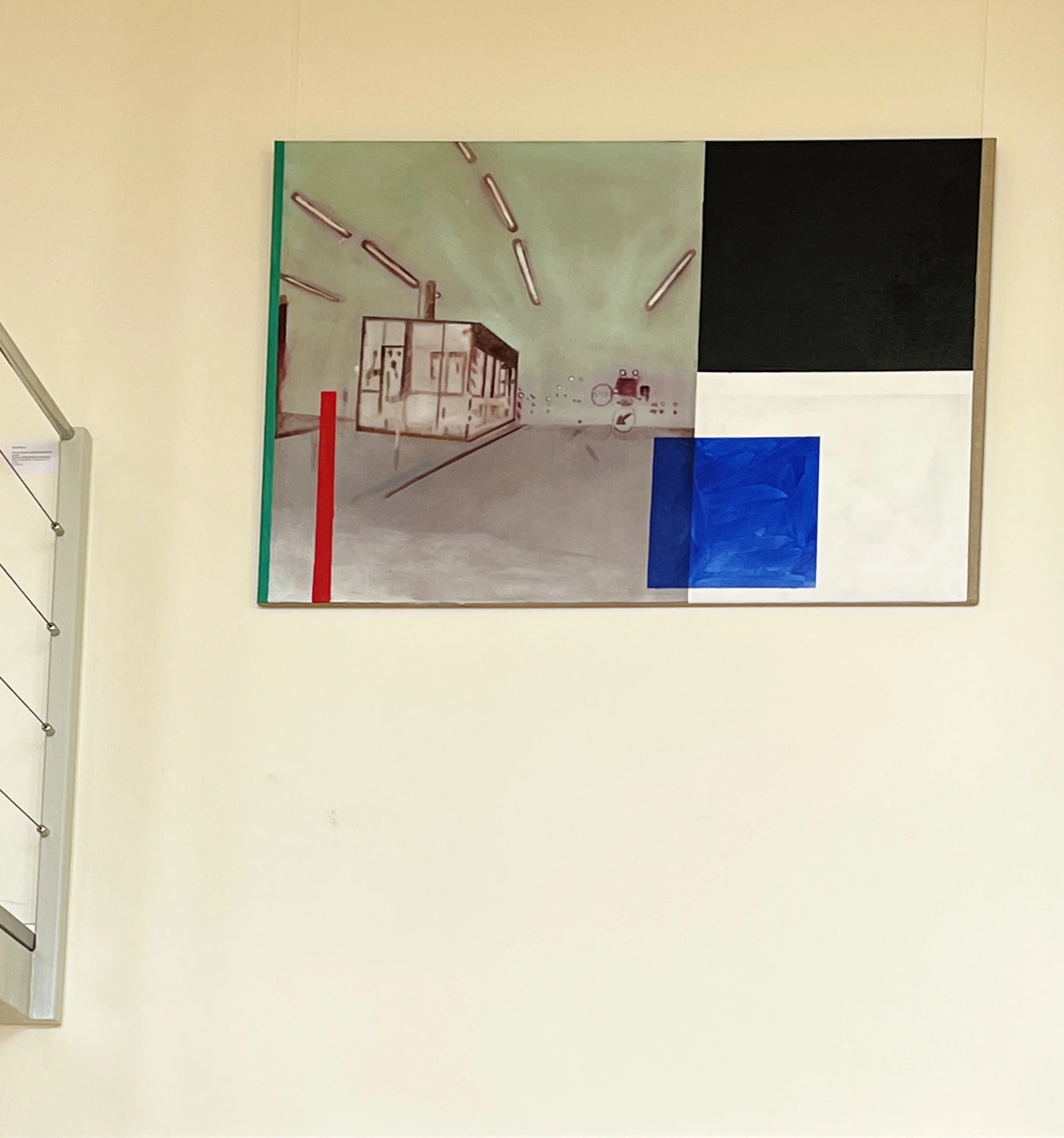A wall with a colorful abstract artwork featuring geometric shapes and lines in various colors.