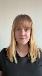 Female physiotherapist in Kew treating lower back and spine pain with hands on treatment