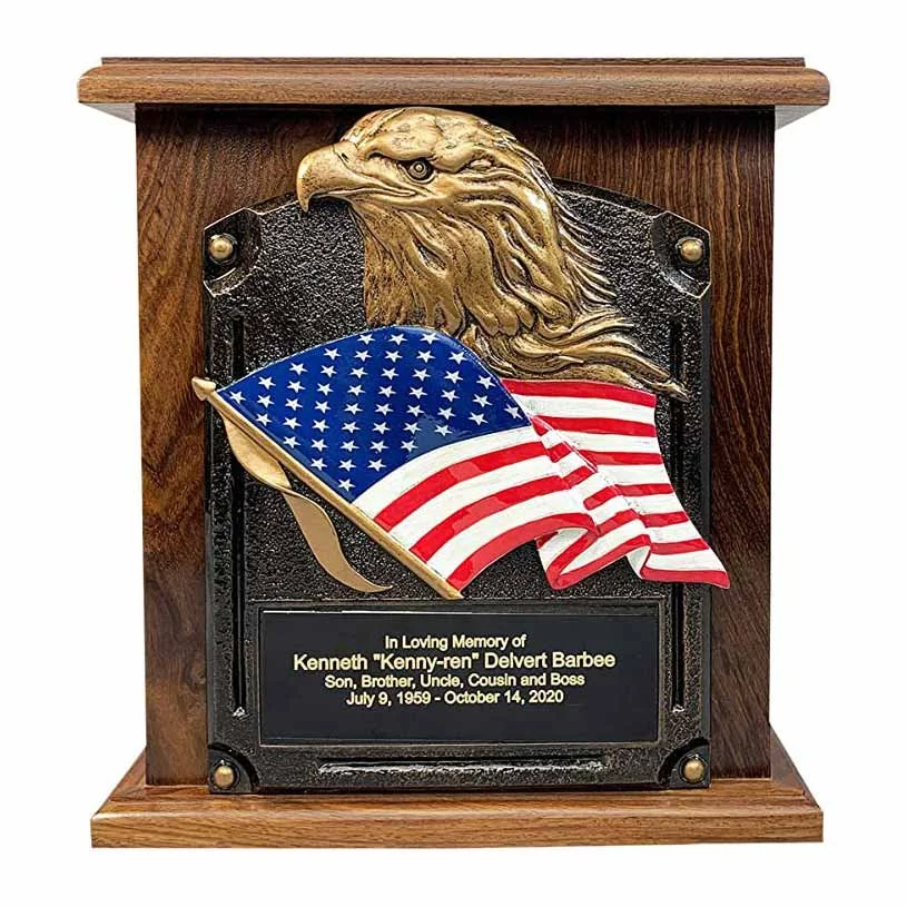 Cremation urn for human ashes with a plaque of an American bald eagle and flag