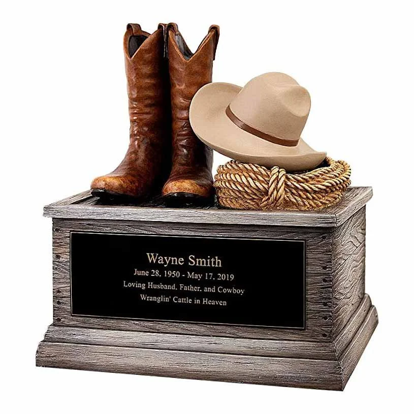 Cremation urn for human ashes shaped like cowboy boots, hat and rope