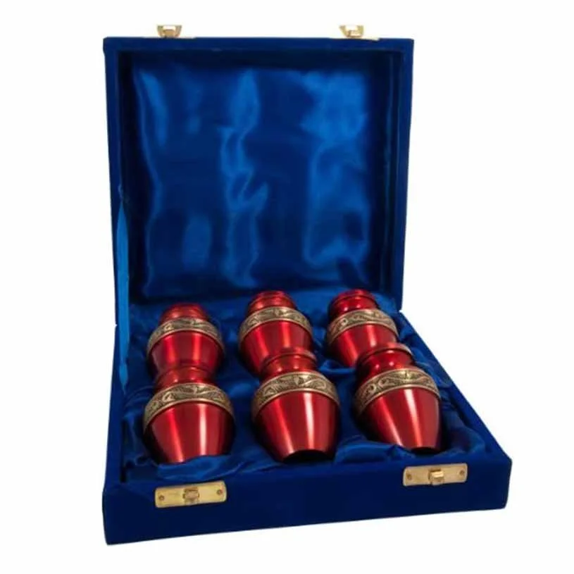 Set of six red brass memorial urns for ashes