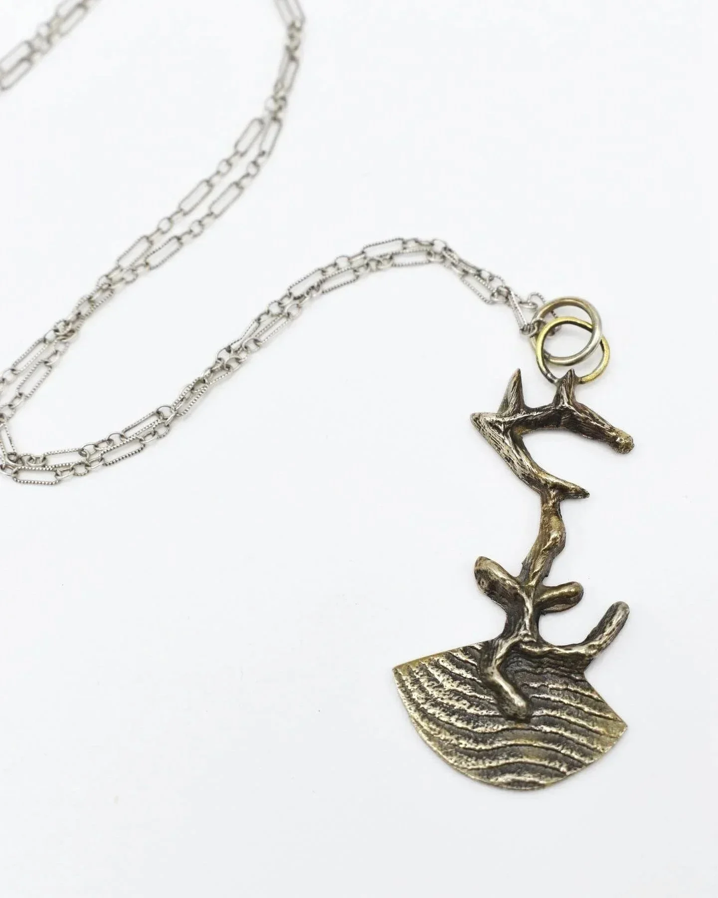 Pendant. 2021. Bronze, silver chain.