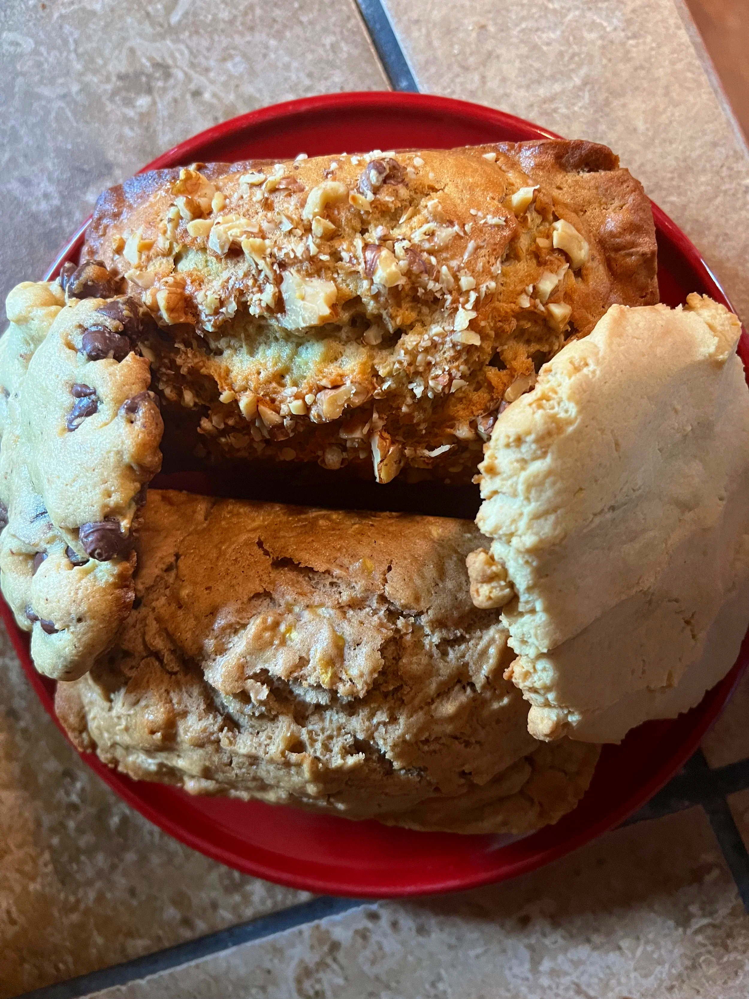 A loaf of banana nut and pumpkin bread, chocolate and peanut butter cookie