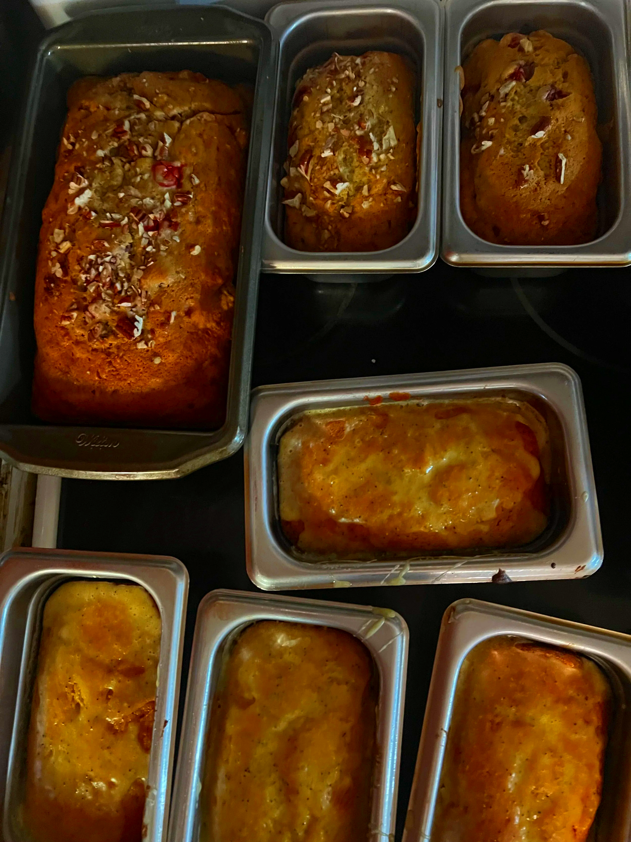 Banana nut bread and orange bread still in pans just baked