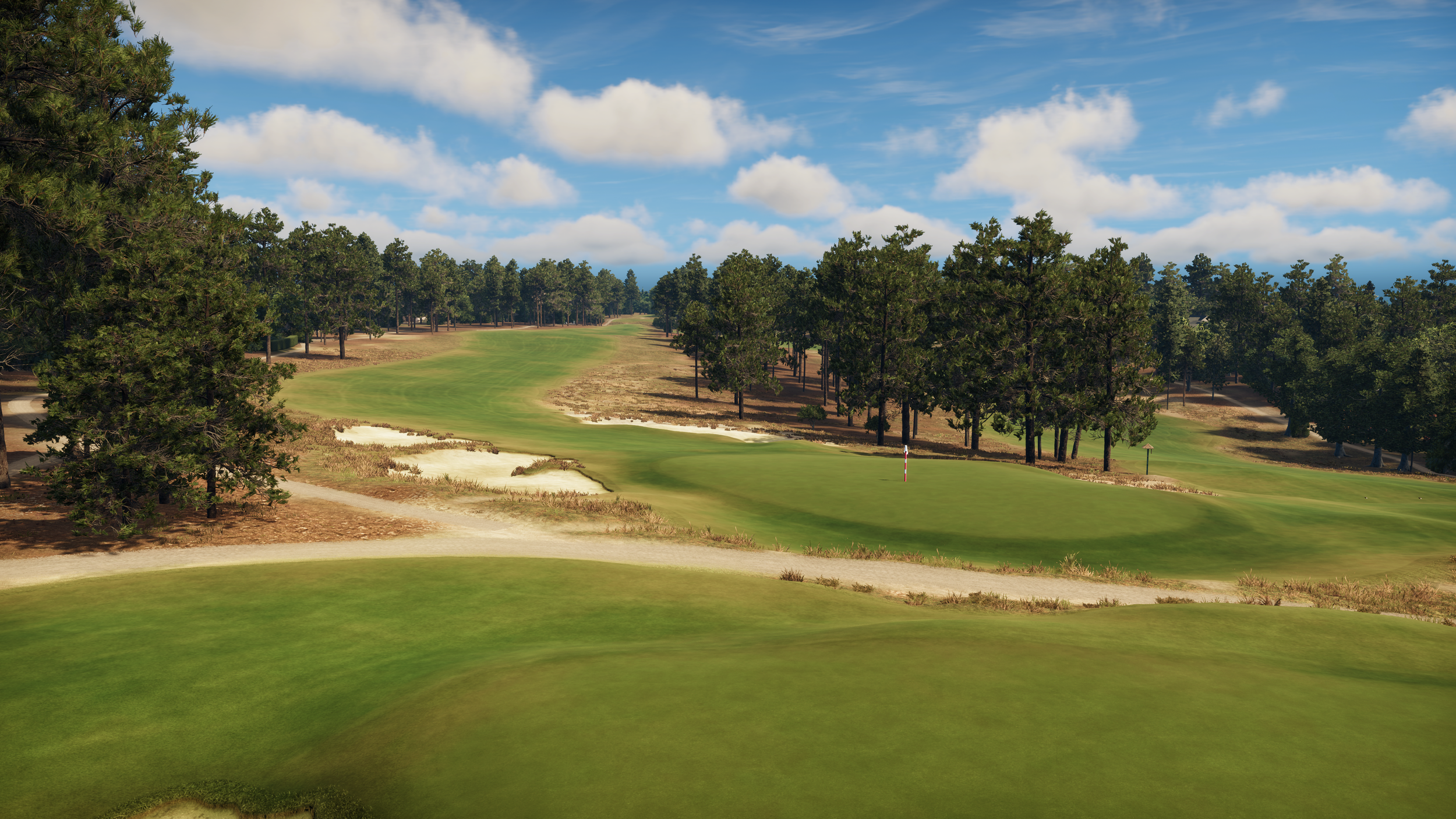 A scenic view of a golf course with green fairways, water hazards, and trees under a partly cloudy sky.