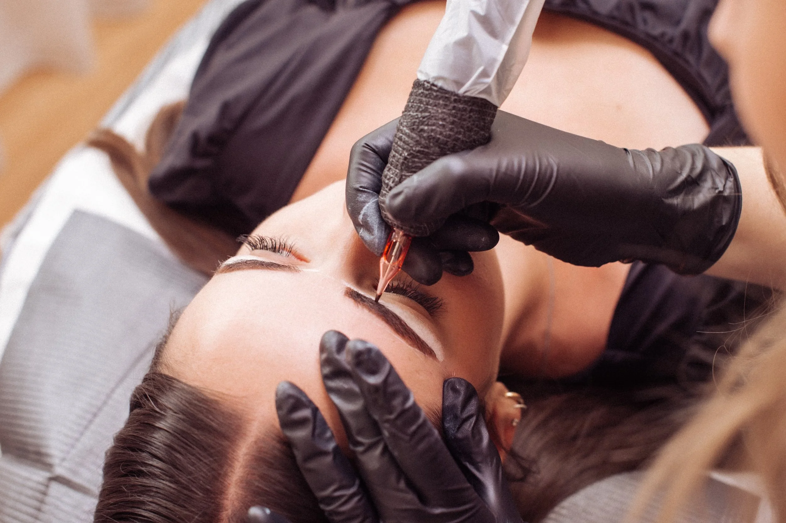 Cosmetic tattoo artist tattooing brows in a beauty salon in Pukekohe in Franklin Auckland