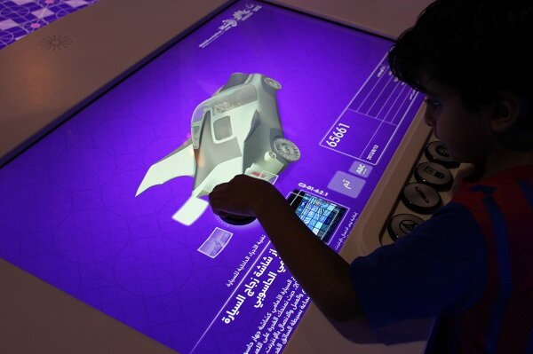 'Future Shaper' Exhibit - Saudi 2050 Travelling Exhibition. Developed by KCA London and Kiss The Frog this exhibit uses pucks to interact with a screen. Each puck represents a different design parameter and turning them gives different options to sel