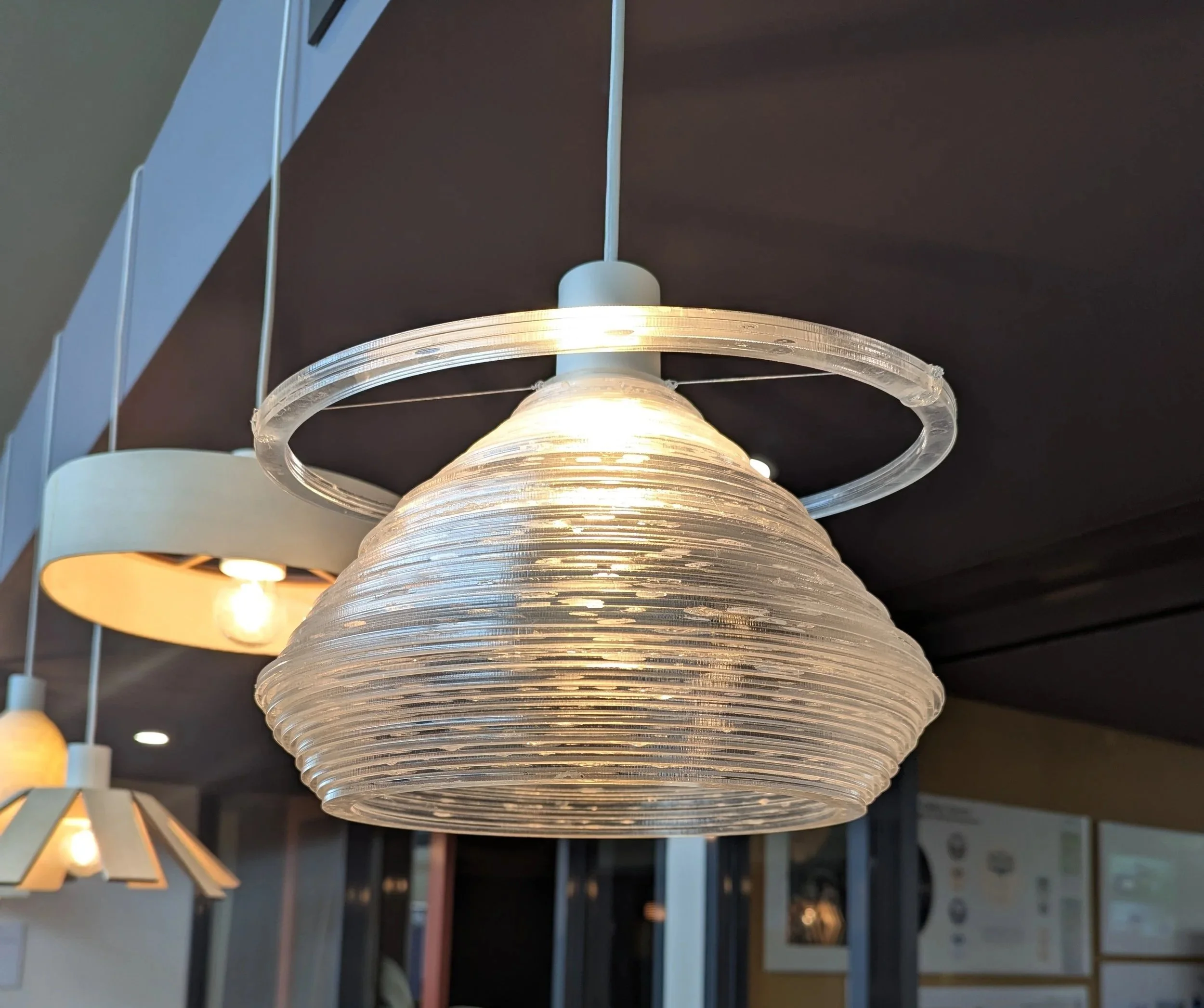 Year 10 Product Design and Technology - Hanging glass-look acrylic lamp with concentric circles made on laser cutter 