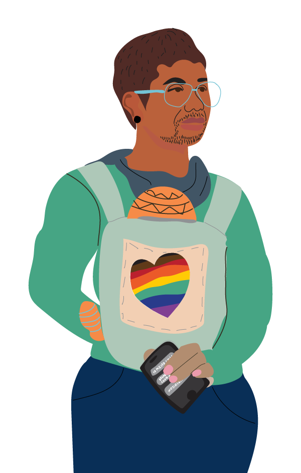 A parent carries a baby on their chest in a carrier. The carrier has a love heart on it in Pride flag colours