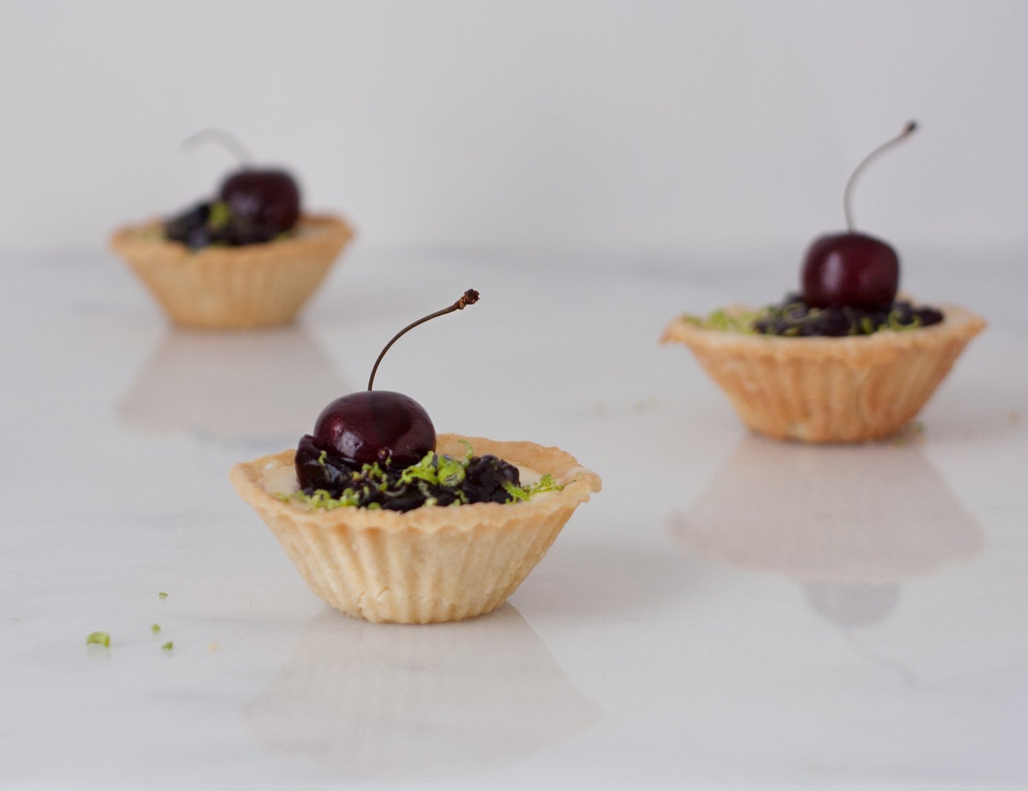 Cherry Amaretto Goat Cheese and Lime Cheesecake Tartlets