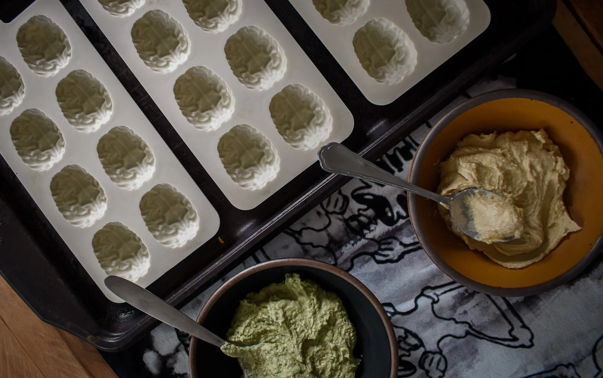 overhead view of silicone molds and two bowls of hummus