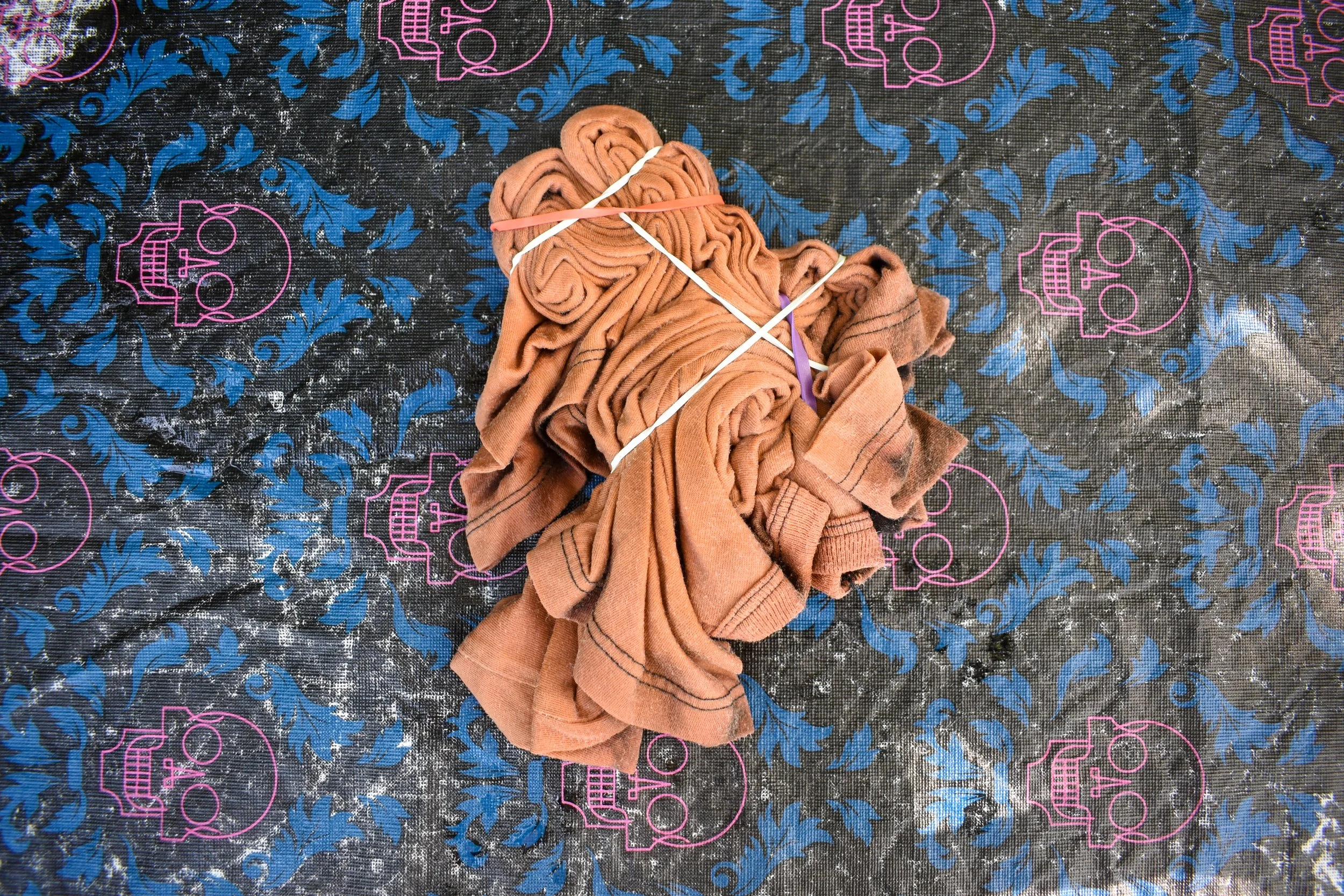 overhead image of a bleached shirt twirled into a spiral and wrapped in rubber bands