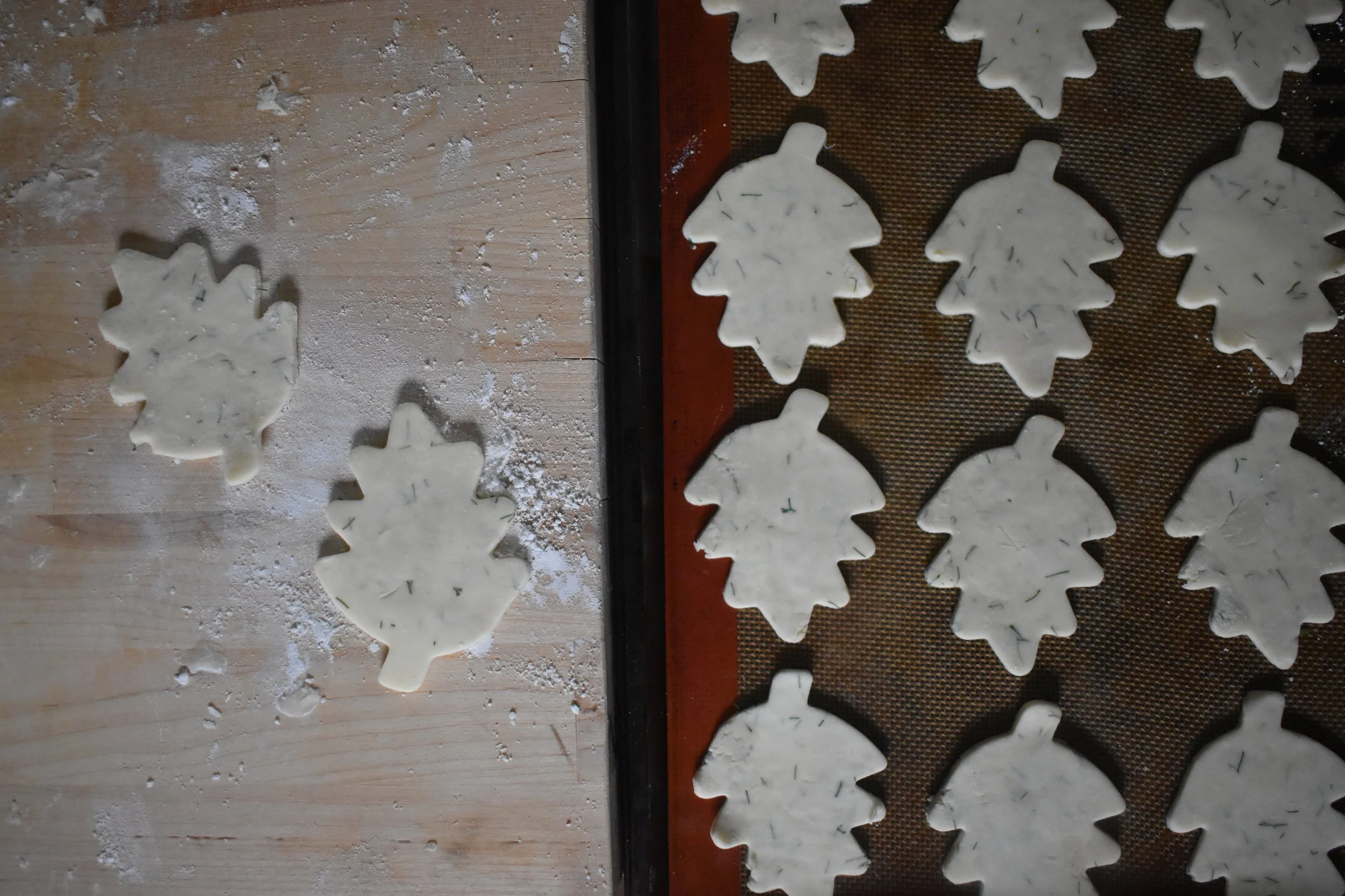  dough cut into the shape of leaves on a baking sheet 