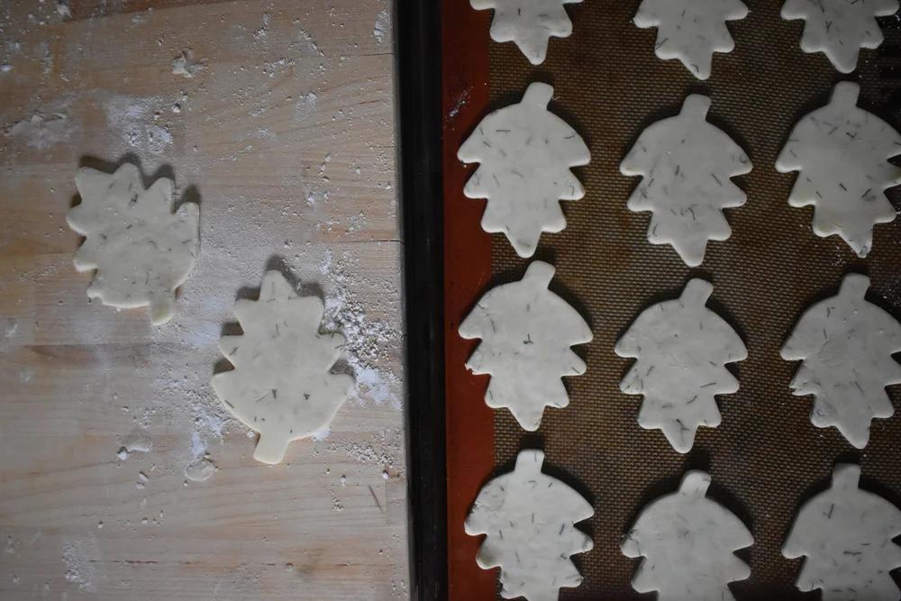  dough cut into the shape of leaves on a baking sheet 