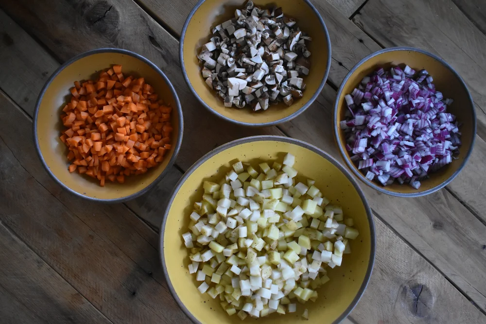  bowls of diced ingredients on a table 