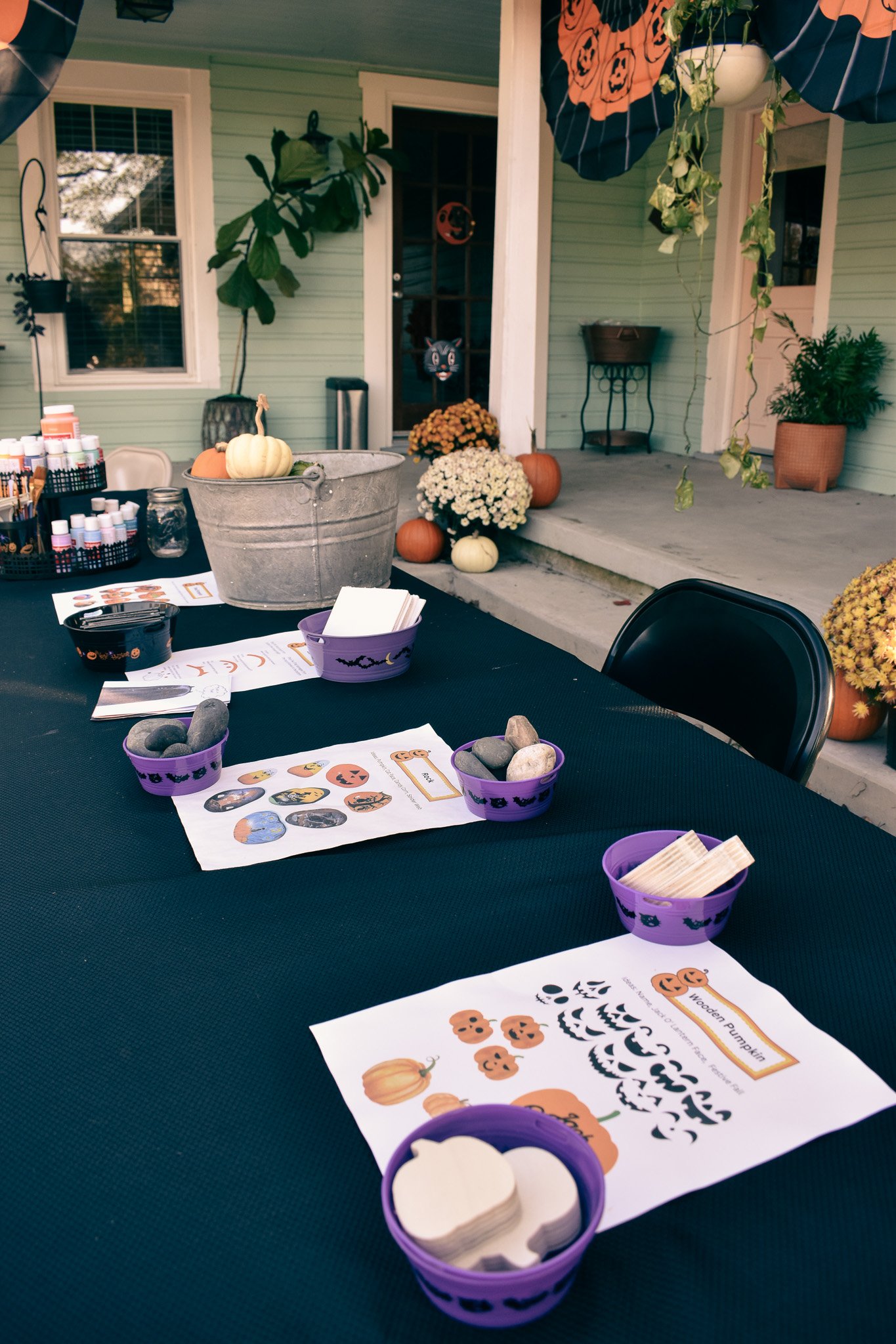 a craft table with instruction sheets for pumpkin crafts