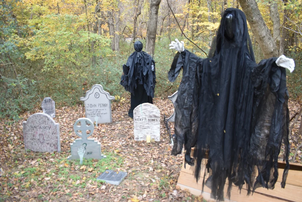  A prop cemetery with ghosts in a wooded area 