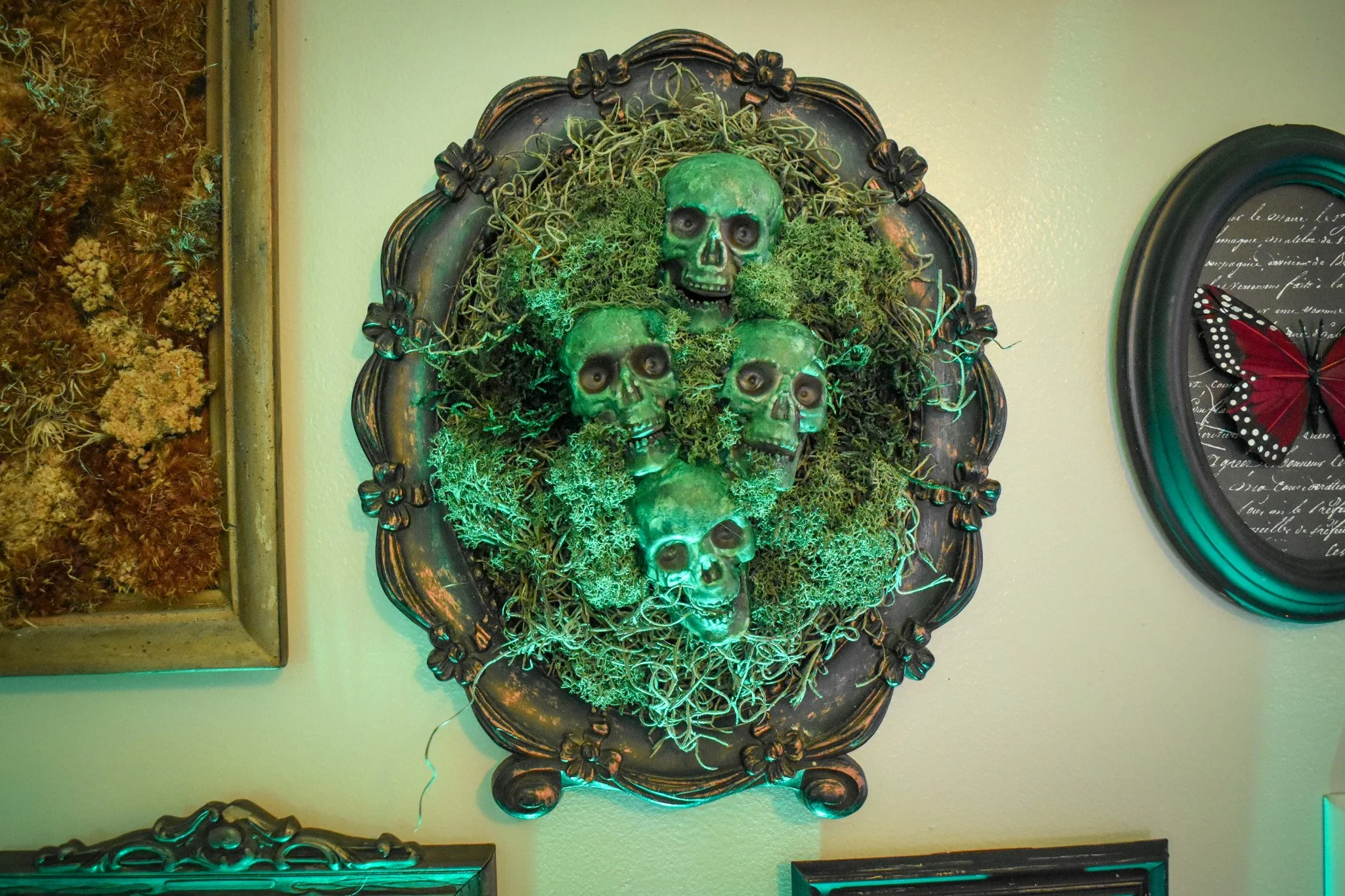 skulls in a mossy frame