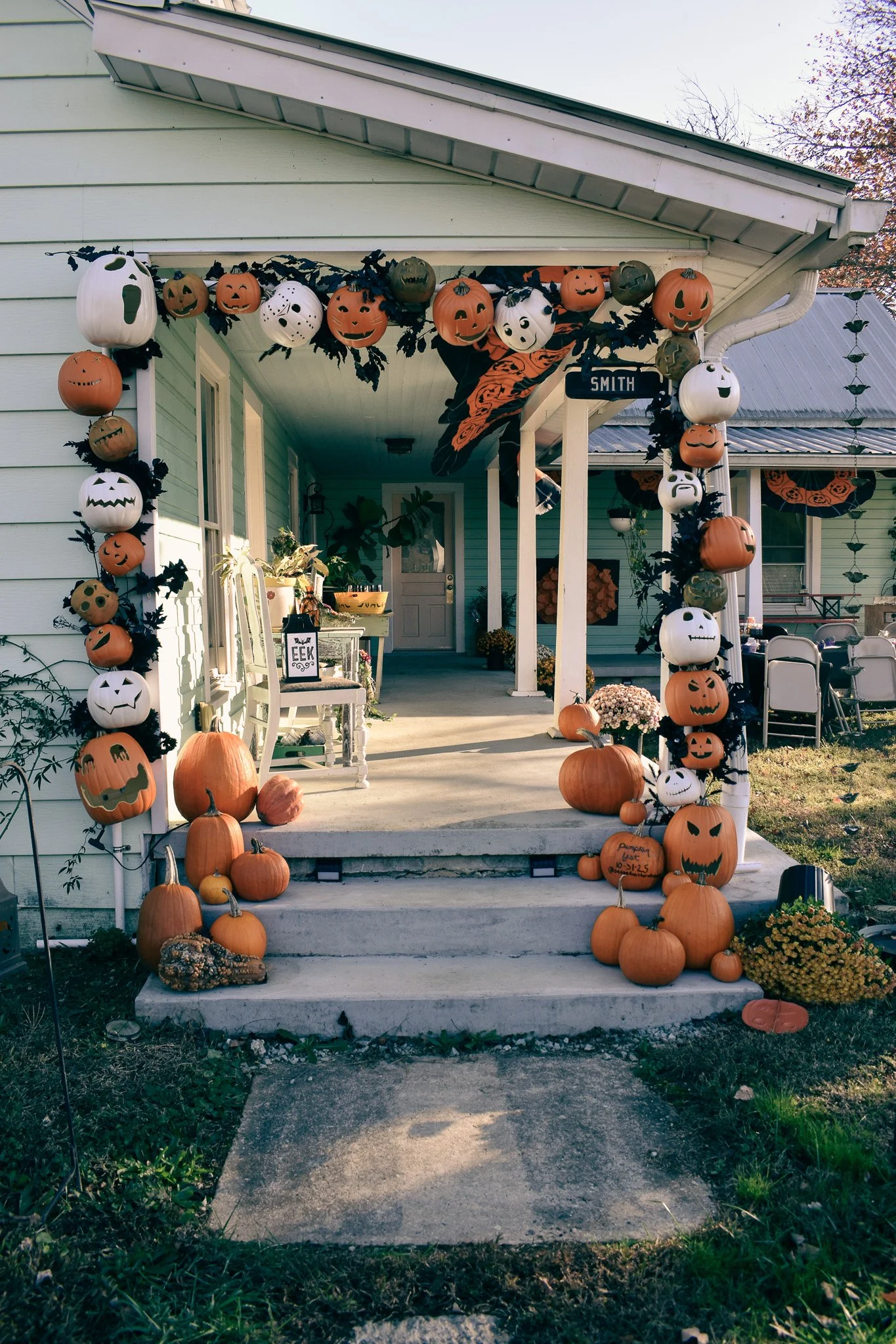 a porch in daylight with an arch pumpkin entry
