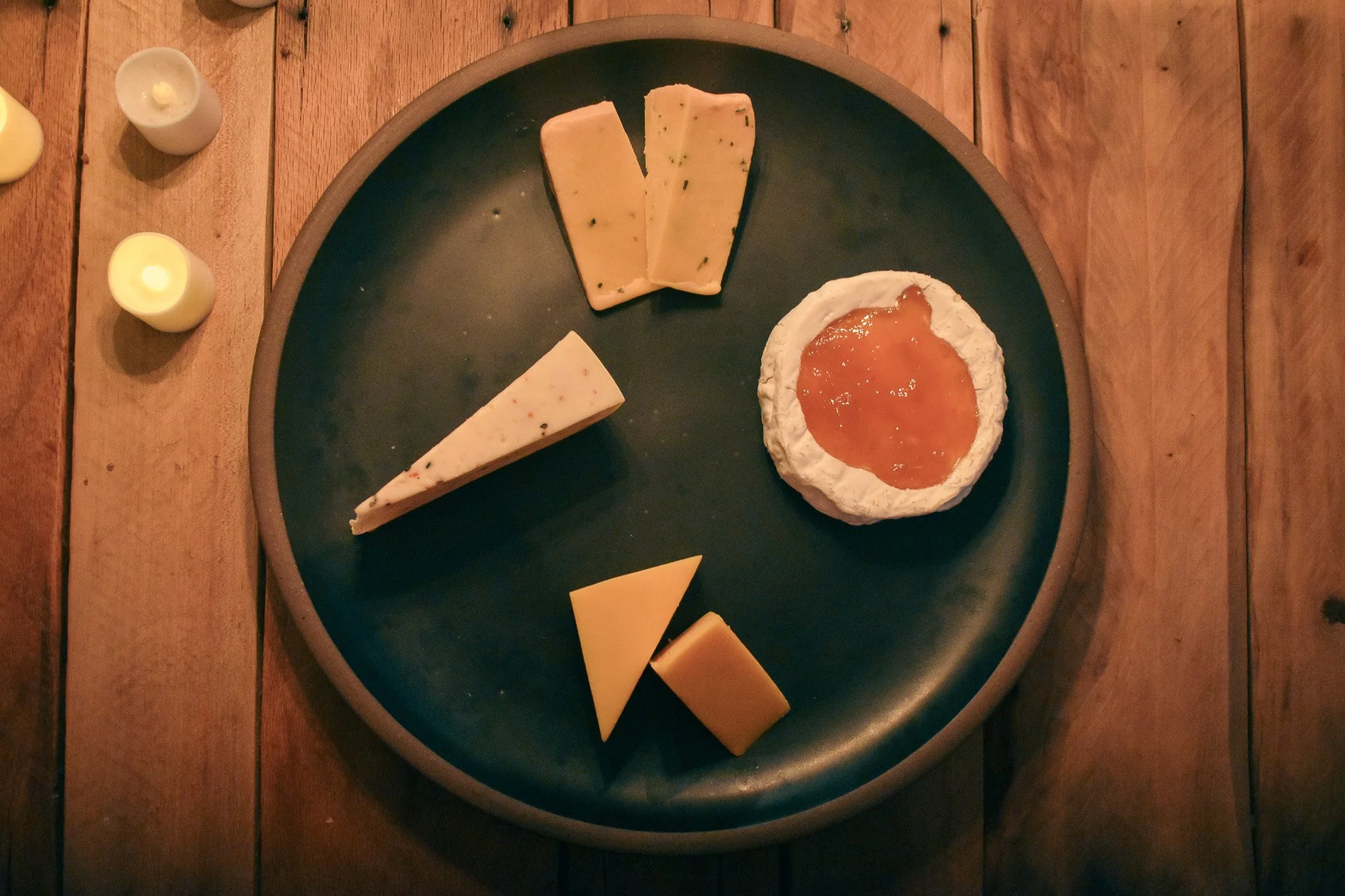 cheese wedges on a black platter