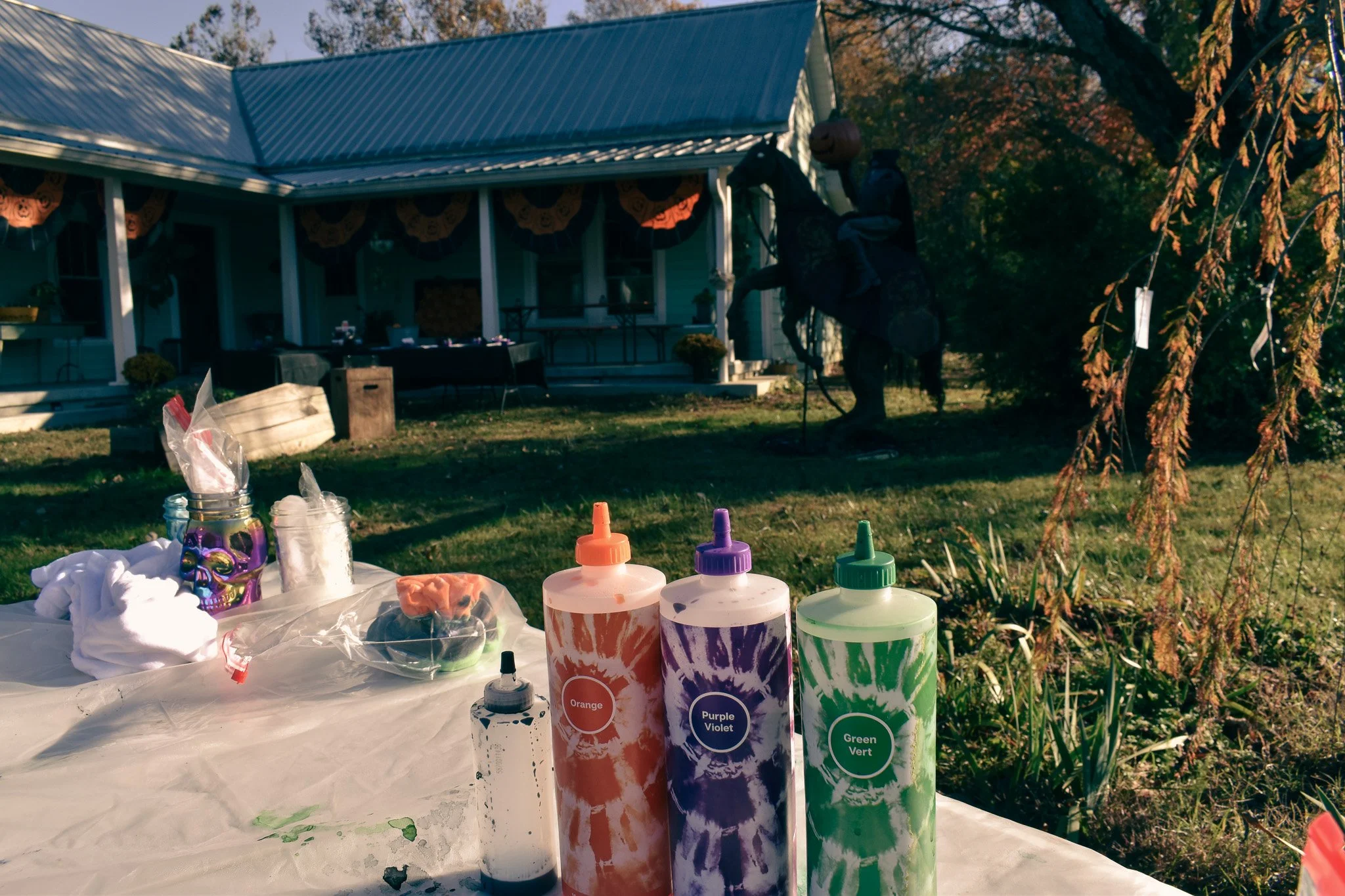 a station with tie-dye bottles with the headless horseman in the background