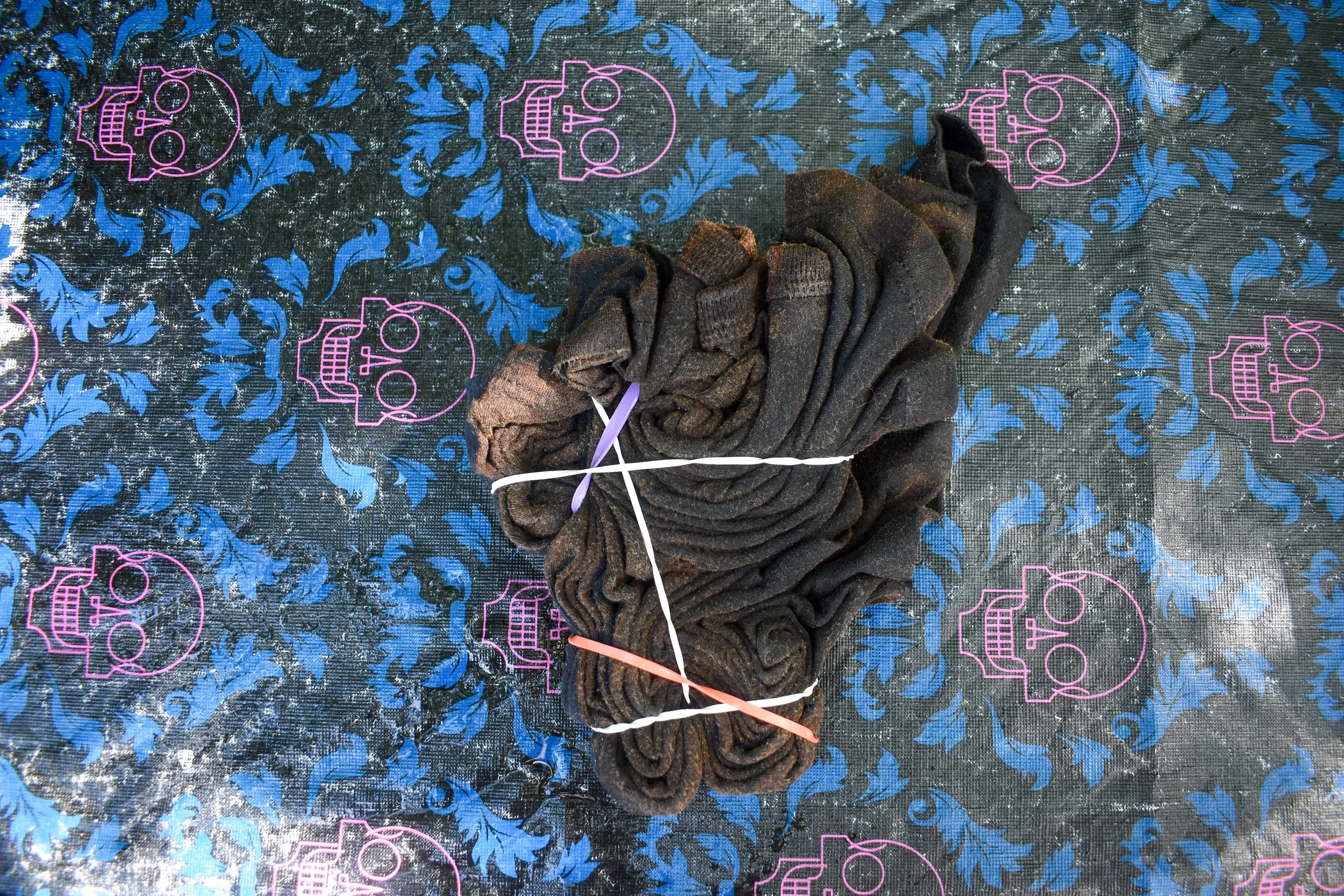 overhead image of a lightly faded shirt twirled into a spiral and wrapped in rubber bands