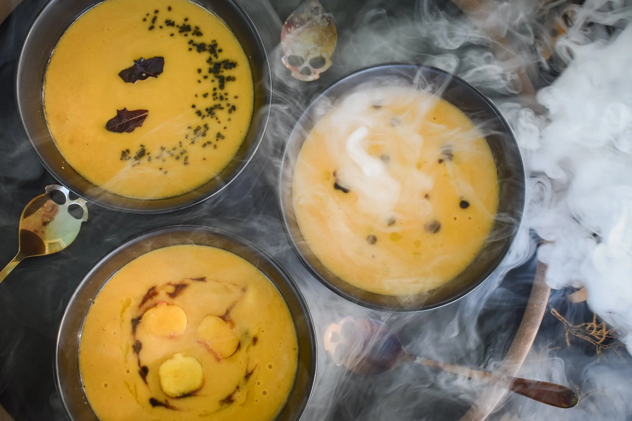 black bowls with orange soup and a drifting fog