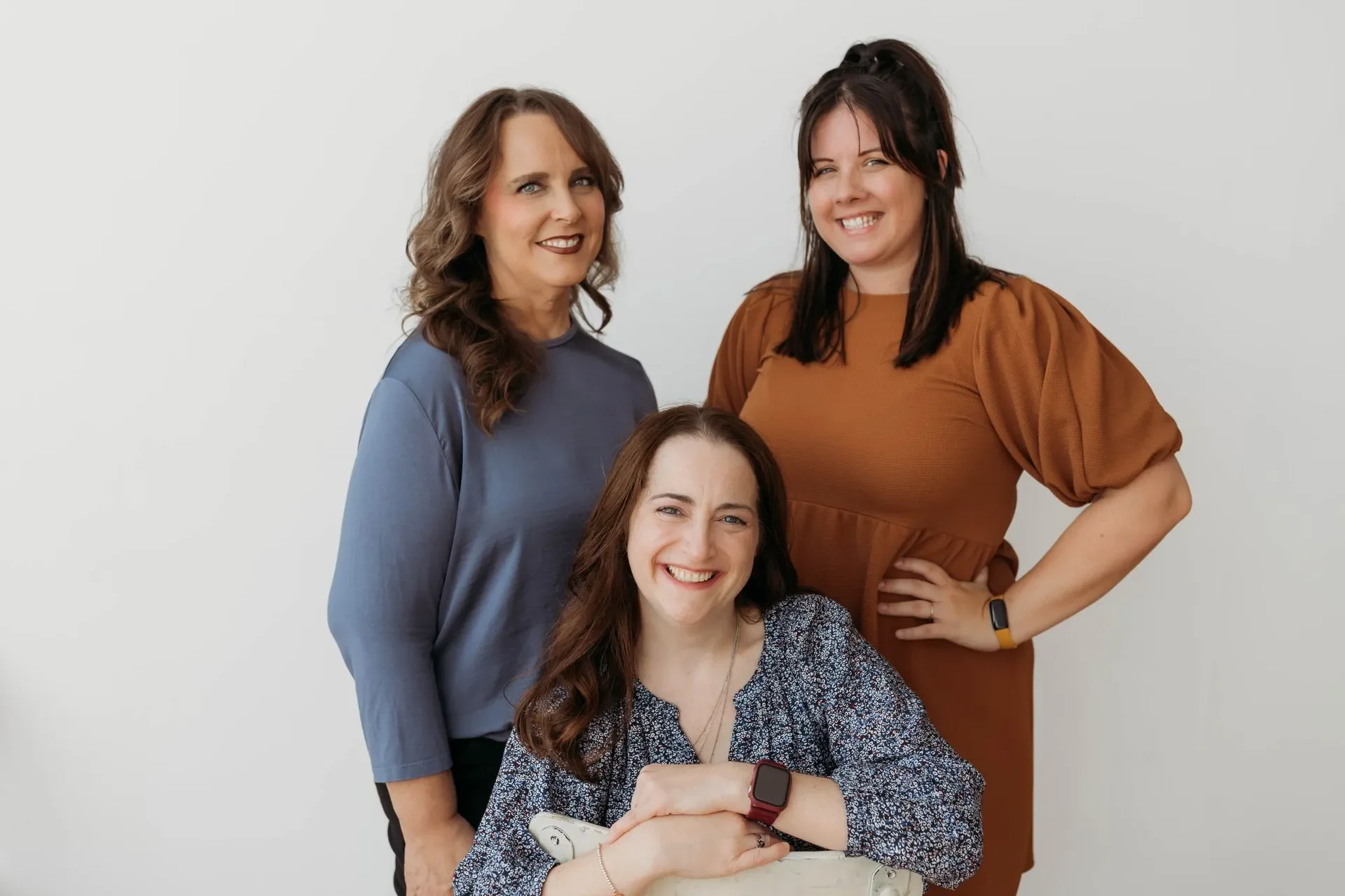 Three lactation consultants smiling together.