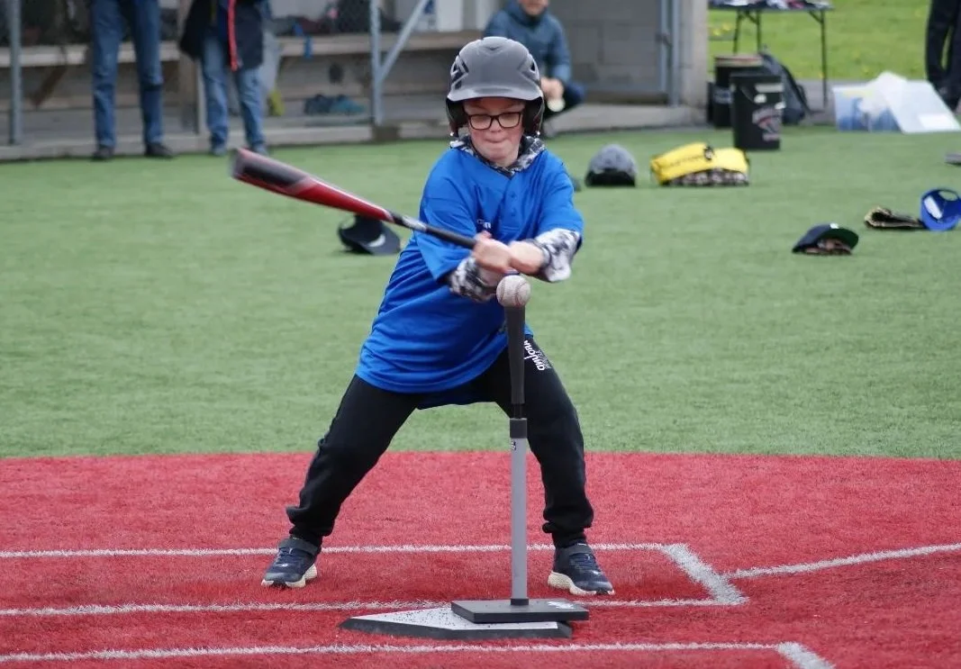 Kid hitting a ball off the tee