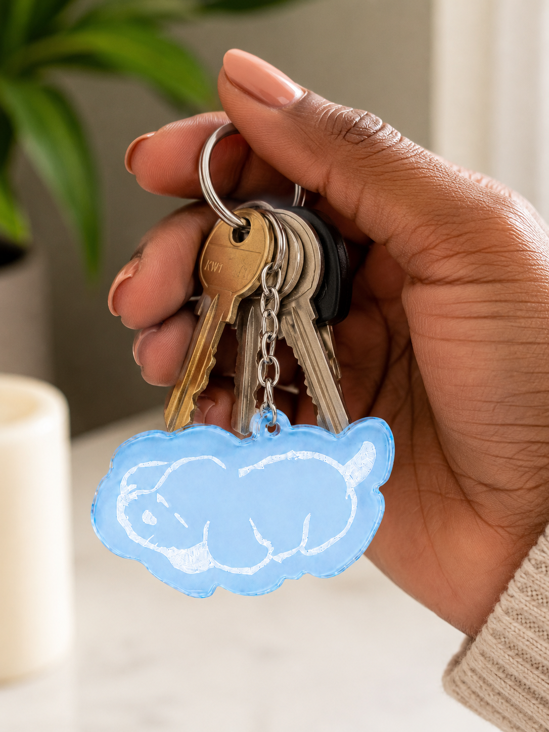 Light blue acrylic keychain featuring an illustration of a sleeping dog