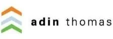 Logo with three upward-pointing arrows in green, blue, and gray, and the text 'adin thomas' next to it.