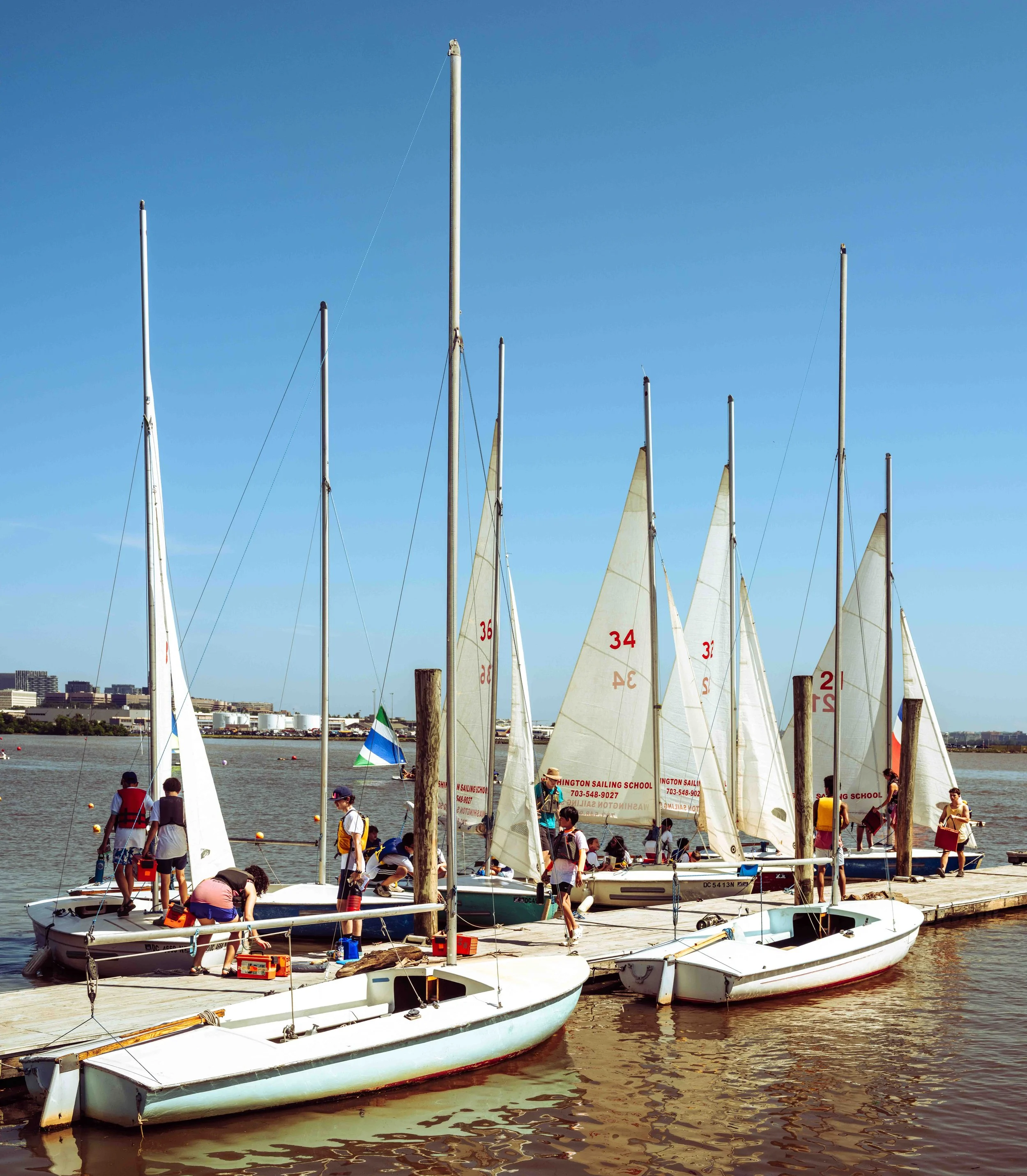 Sailboats gather near the marina following a day of instruction and practice on the water.